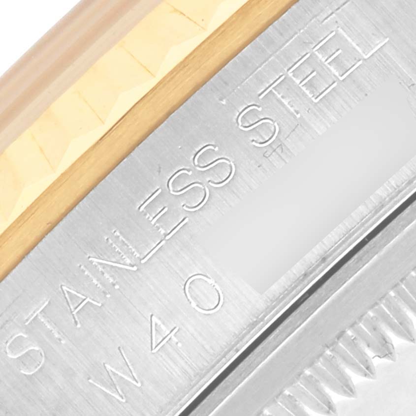 The image shows a close-up of the side of a Rolex Datejust 16233 Men's Steel and Gold (two tone) White Dial 16233 Men's Steel and Gold (two tone) White Dial watch, highlighting the stainless steel edge and fluted bezel.