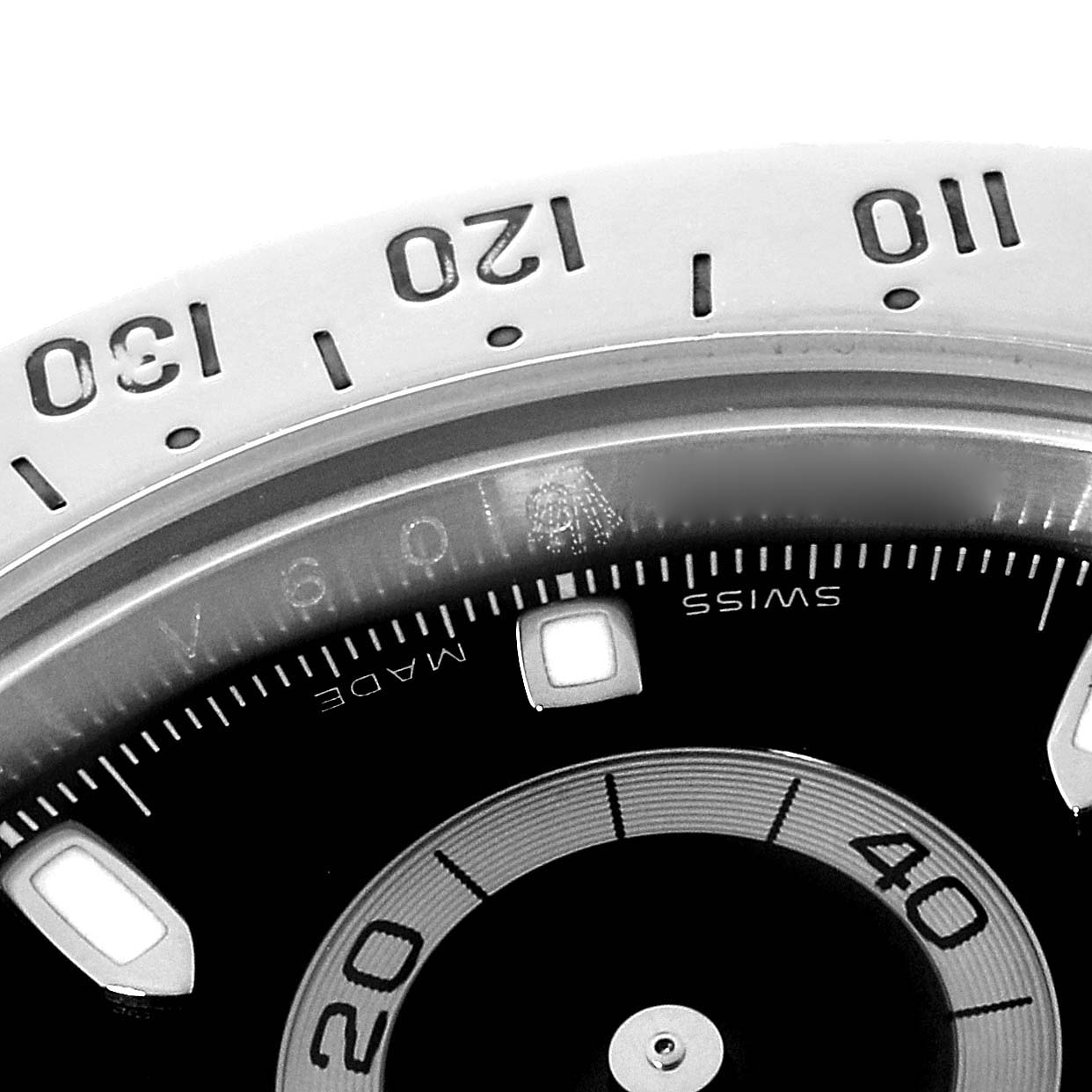 The image shows a close-up of the bezel and part of the dial of a Rolex Daytona 116520 Men's Stainless Steel Black Dial 116520 Men's Stainless Steel Black Dial watch, focusing on the tachymeter scale.