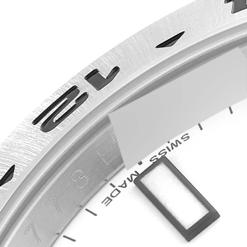 This image shows a close-up of the bezel and part of the dial of a Rolex Explorer 216570 Men
s Stainless Steel White Dial 216570 Men
s Stainless Steel White Dial watch, including some numerals and text.