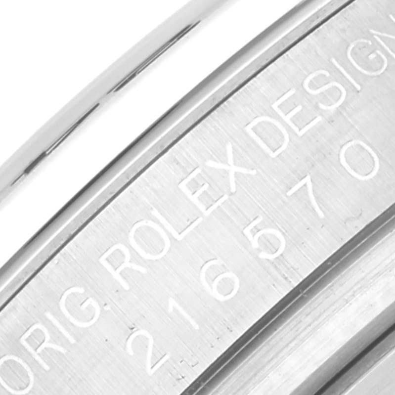 The image shows an angled close-up of the engraved serial number on a Rolex Explorer 216570 Men
s Stainless Steel White Dial 216570 Men
s Stainless Steel White Dial watch case.