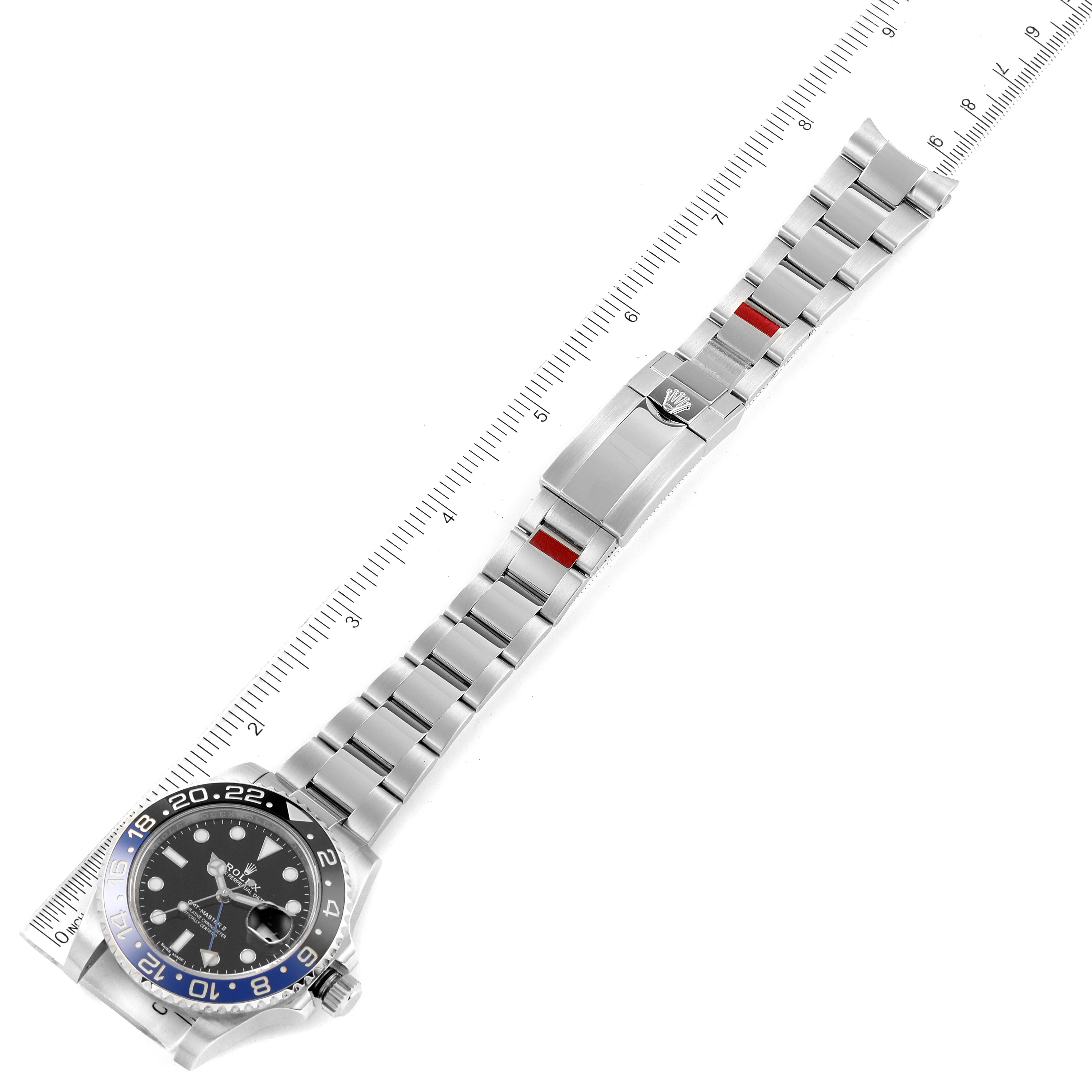 The image shows a Rolex GMT-Master 116710 Men
s Stainless Steel Black Dial 116710 Men
s Stainless Steel Black Dial watch, displaying the full length of the bracelet and the watch face from a top-down angle alongside a ruler.
