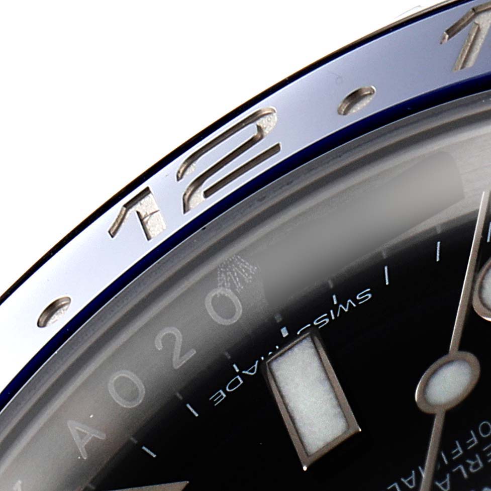 The image shows a close-up view of the bezel and part of the dial of a Rolex GMT-Master 116710 Men
s Stainless Steel Black Dial 116710 Men
s Stainless Steel Black Dial watch.