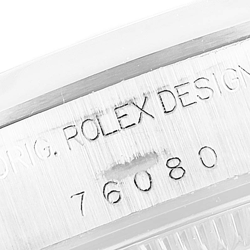 This image shows a close-up of the serial number engraving on a Rolex Oyster Perpetual 76080 Women
s Stainless Steel Blue Dial 76080 Women
s Stainless Steel Blue Dial watch case.