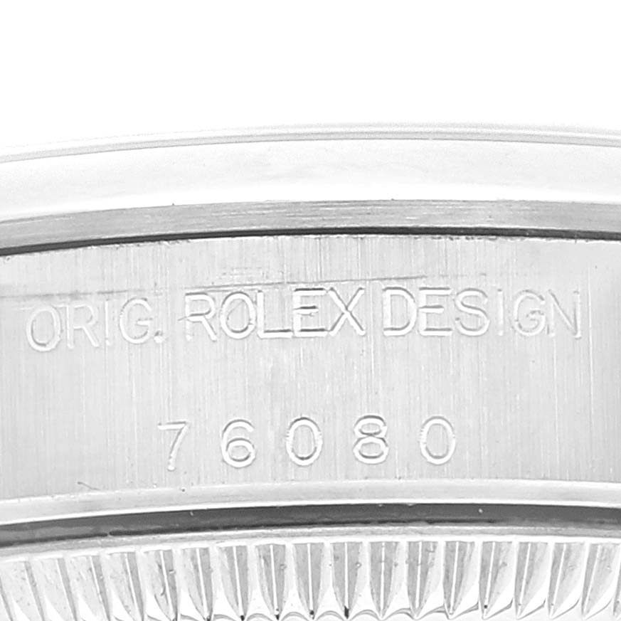 The image shows a close-up of the case back with engravings on an Oyster Perpetual Rolex watch.