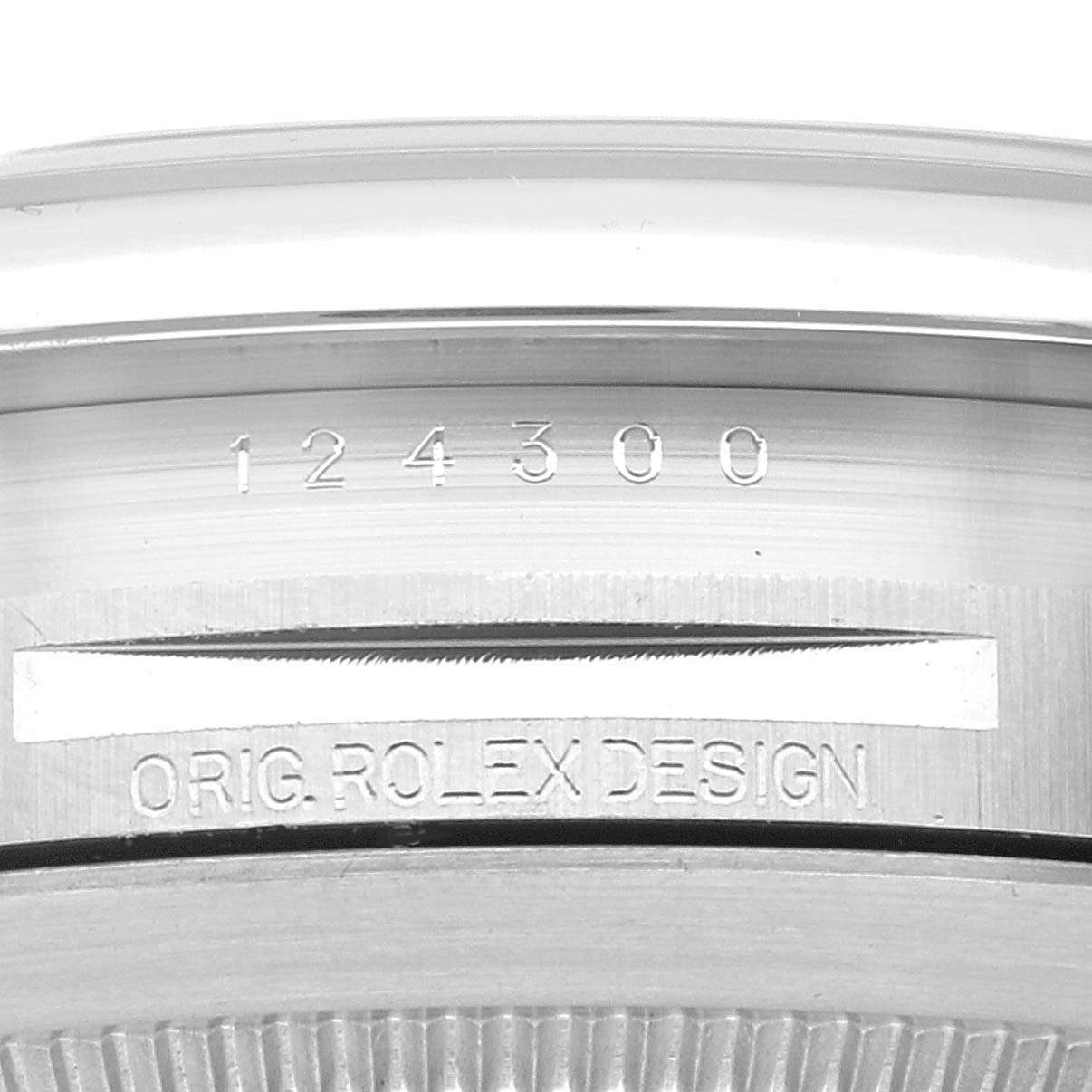 This image shows the case back and model number of the Rolex Oyster Perpetual 124300 Men
s Stainless Steel Black Dial 124300 Men
s Stainless Steel Black Dial watch, specifically displaying "124300" and "ORIG. ROLEX DESIGN".