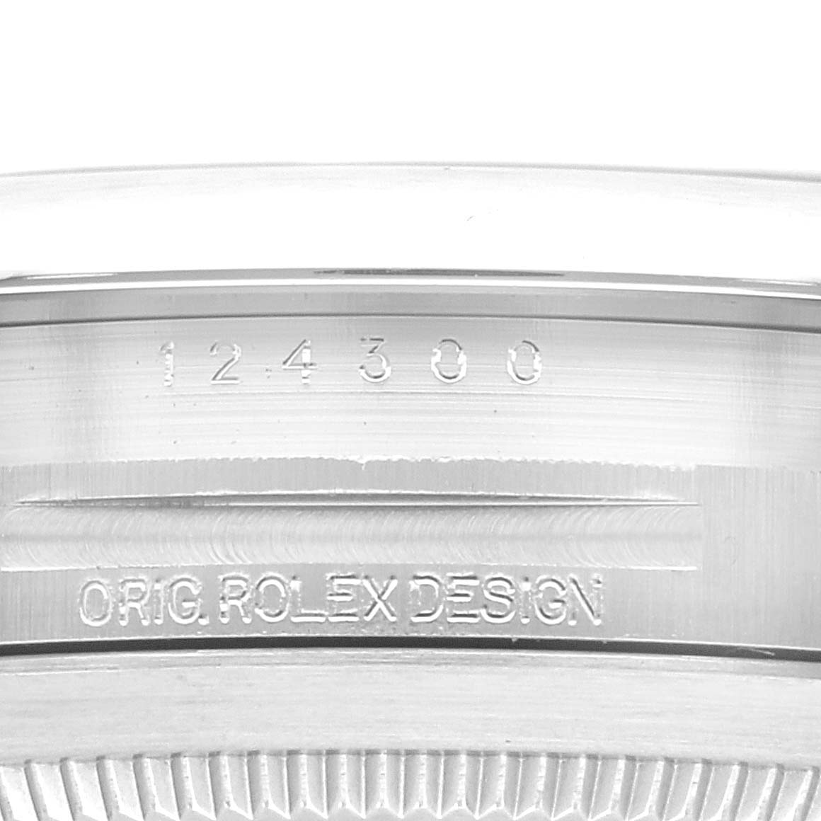 The image shows a close-up of the casing and engraving on the back of a Rolex Oyster Perpetual 124300 Men
s Stainless Steel Blue Dial 124300 Men
s Stainless Steel Blue Dial watch model 124300.