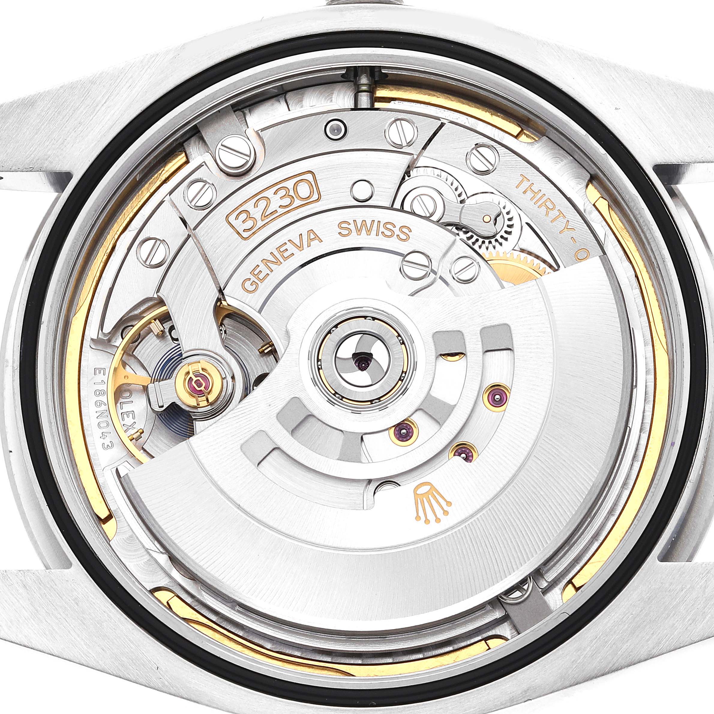 The image shows the internal movement of a Rolex Oyster Perpetual 124300 Men
s Stainless Steel Blue Dial 124300 Men
s Stainless Steel Blue Dial watch from a back angle, highlighting the mechanism and components.