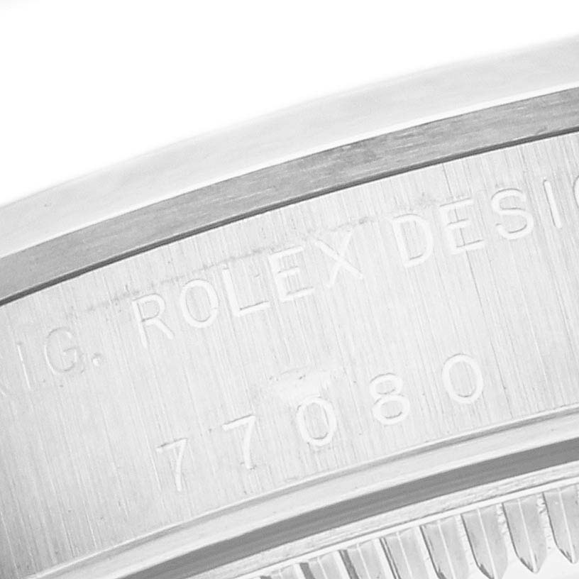The image shows a close-up of the case side of a Mid-Size Rolex watch, highlighting the "ROLEX DESIGN 77080" engraving.