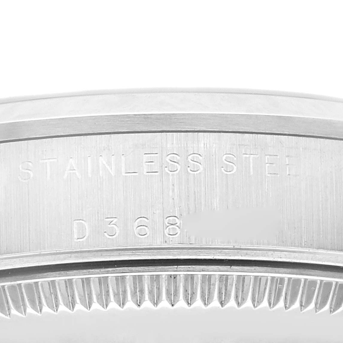 The image shows the side of the Mid-Size model Rolex watch with engravings indicating "STAINLESS STEEL" and a partial serial number.