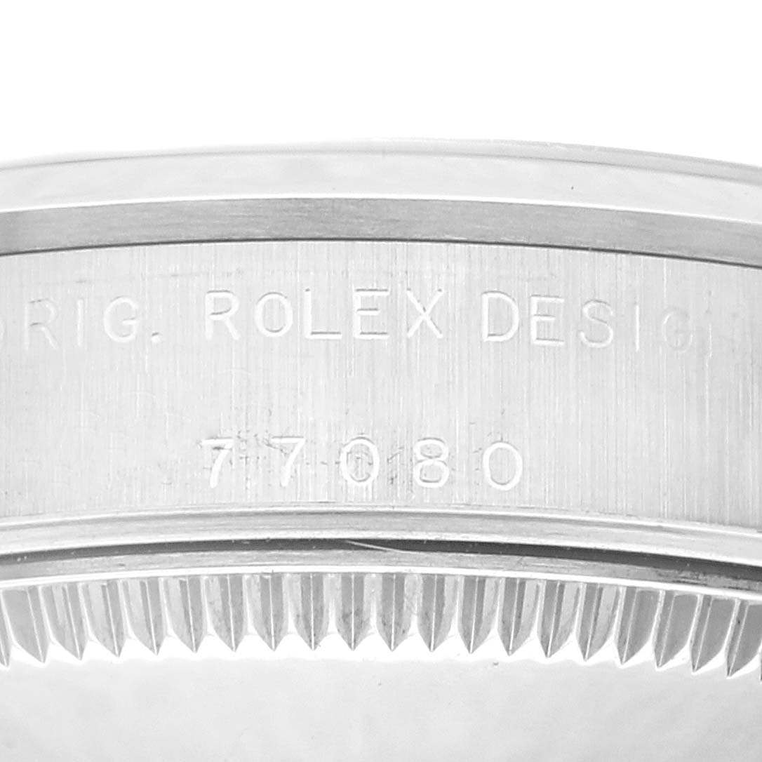 The image shows a close-up of the engraved case back and edge of a Rolex Mid-Size 77080 Women's Stainless Steel Pink Dial 77080 Women's Stainless Steel Pink Dial model watch with the model number visible.