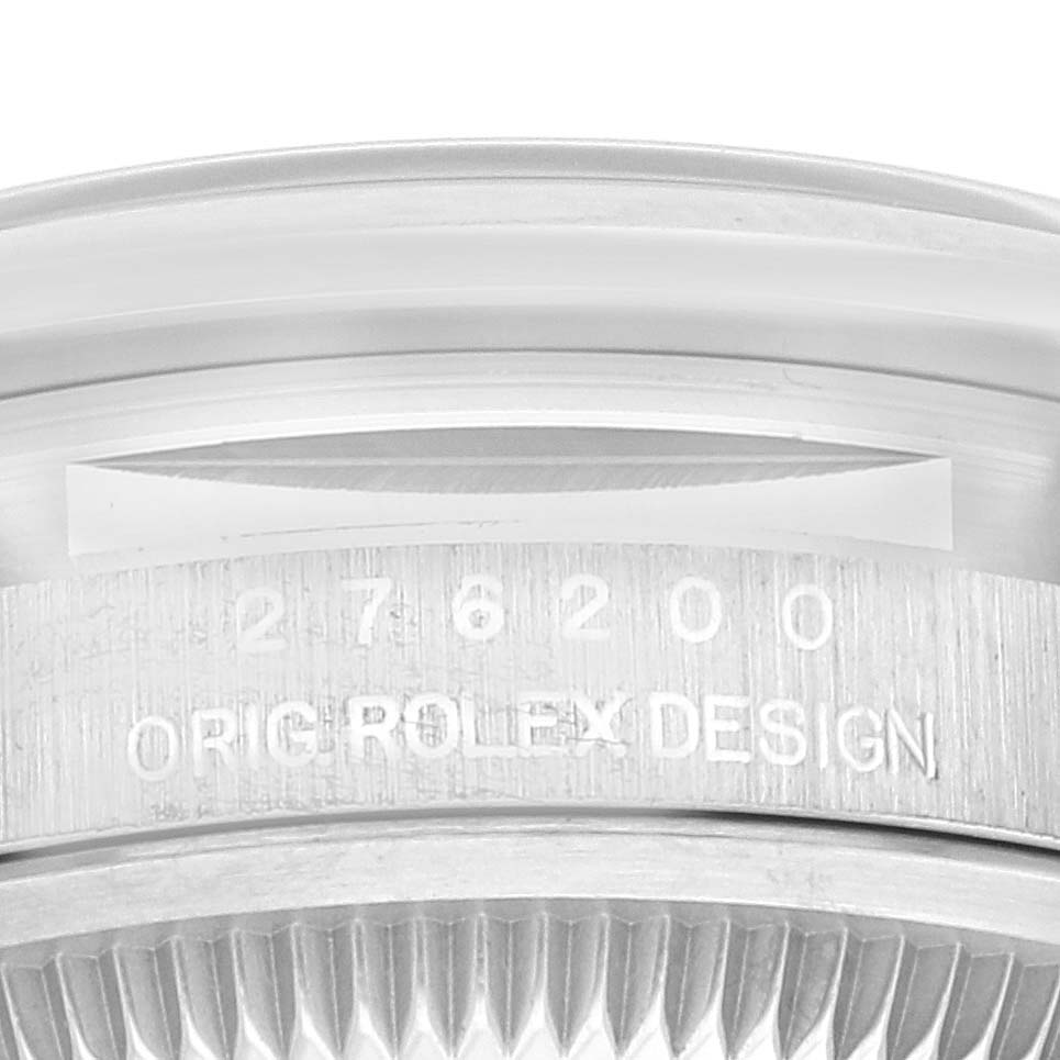 The image shows a close-up of the side of a Rolex Oyster Perpetual 276200 Women's Stainless Steel Black Dial 276200 Women's Stainless Steel Black Dial watch, highlighting the model number and "ORIG ROLEX DESIGN" engraving.