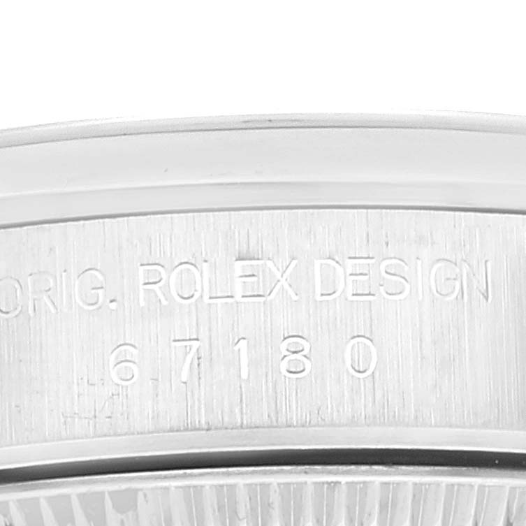This image shows a close-up of the engraved case back detailing on a Rolex Oyster Perpetual 67180 Women
s Stainless Steel Pink Dial 67180 Women
s Stainless Steel Pink Dial watch.