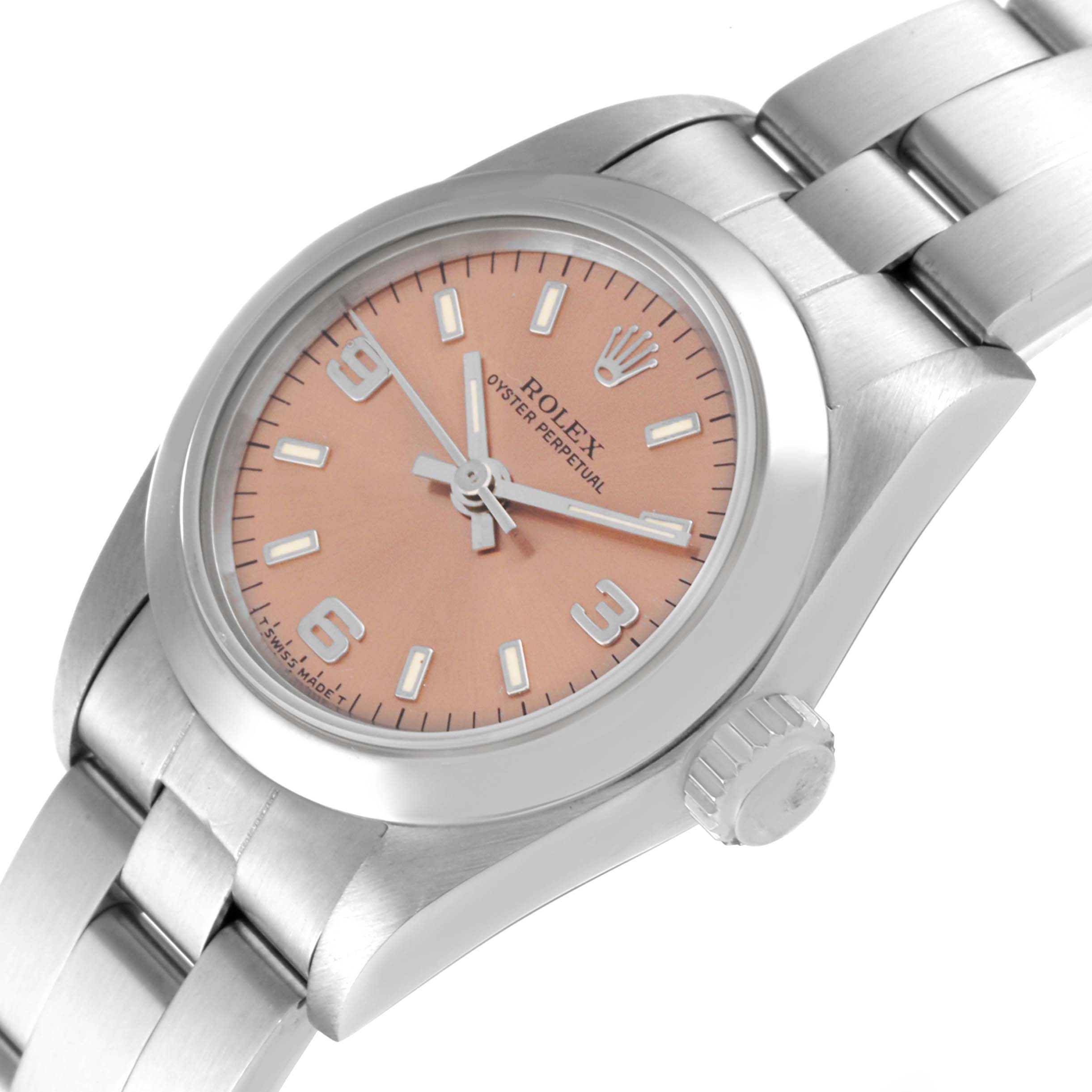 The image shows a Rolex Oyster Perpetual 67180 Women
s Stainless Steel Pink Dial 67180 Women
s Stainless Steel Pink Dial watch at an angled close-up, highlighting the dial, crown, and part of the bracelet.