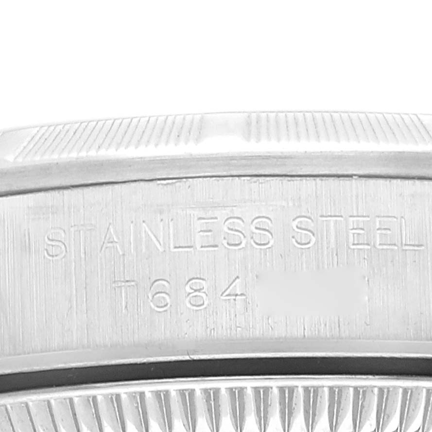 This image shows the side engraving on the stainless steel case back of a Rolex Oyster Perpetual 67230 Women
s Stainless Steel Pink Dial 67230 Women
s Stainless Steel Pink Dial watch.