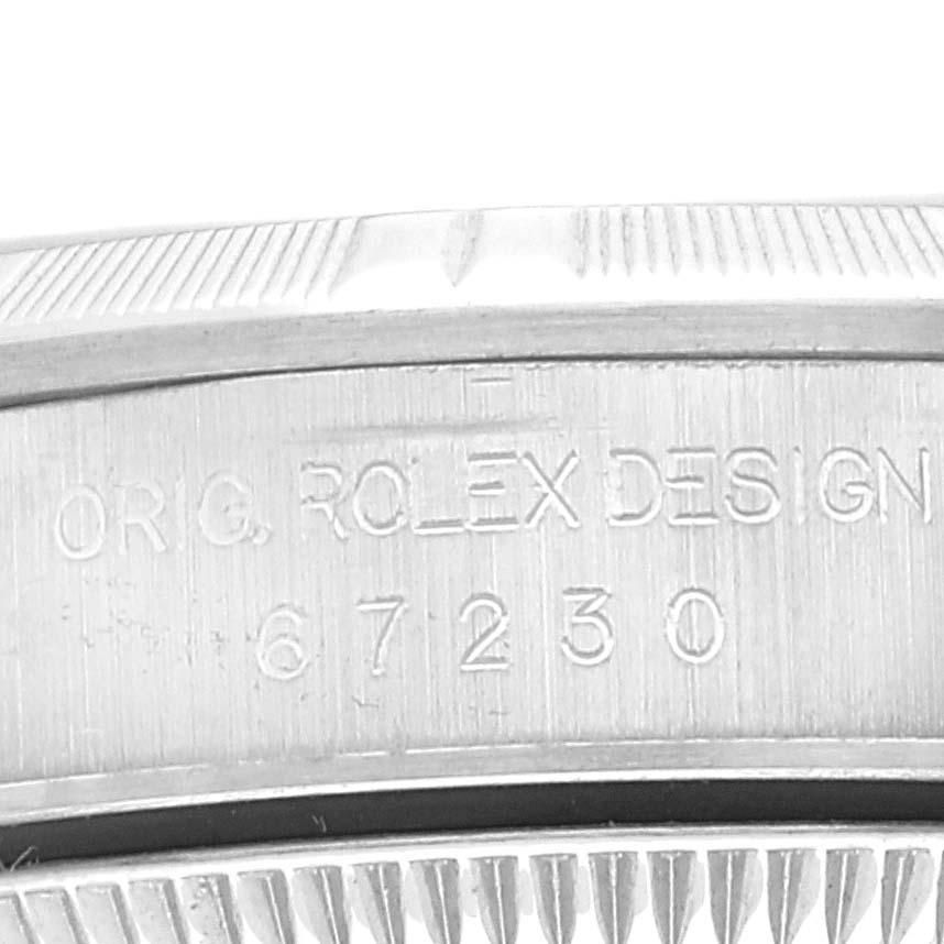This image shows a close-up of the bezel and case side of the Rolex Oyster Perpetual 67230 Women
s Stainless Steel Pink Dial 67230 Women
s Stainless Steel Pink Dial watch.