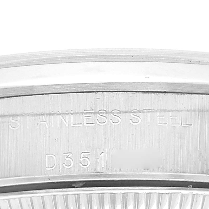 This image shows a close-up of the case back edge of a Rolex Oyster Perpetual 76080 Women
s Stainless Steel Pink Dial 76080 Women
s Stainless Steel Pink Dial watch, highlighting its stainless steel construction.