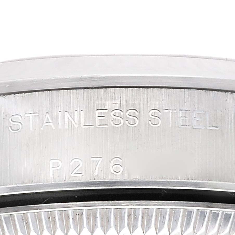 This close-up image shows the side engraving on the case back of a Rolex Oyster Perpetual 76080 Women
s Stainless Steel Pink Dial 76080 Women
s Stainless Steel Pink Dial watch, revealing "STAINLESS STEEL" and a partial reference number.