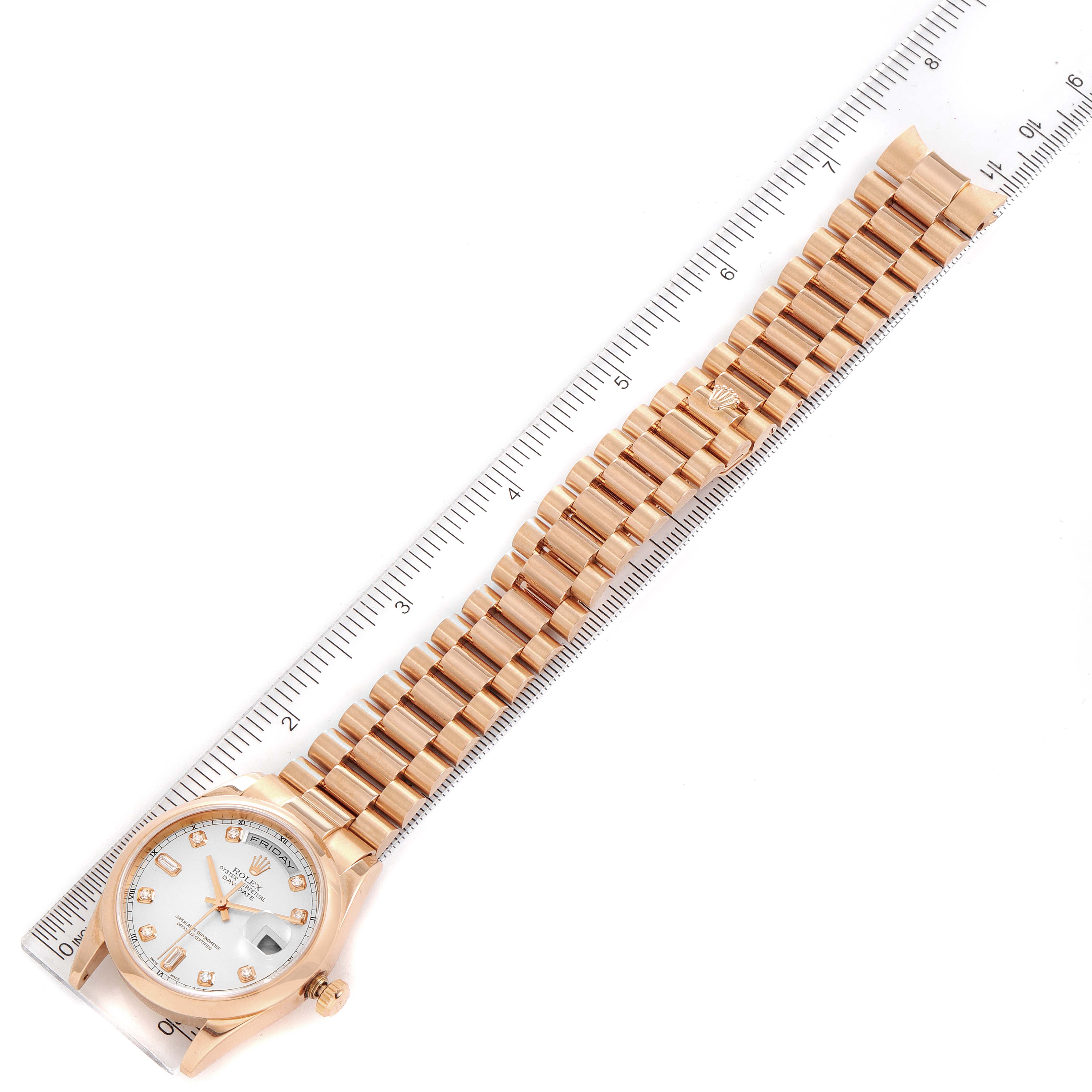 The image shows a Rolex President 118205 Men's Rose Gold Silver Dial 118205 Men's Rose Gold Silver Dial model watch, including its face, case, and full bracelet, placed alongside a ruler.