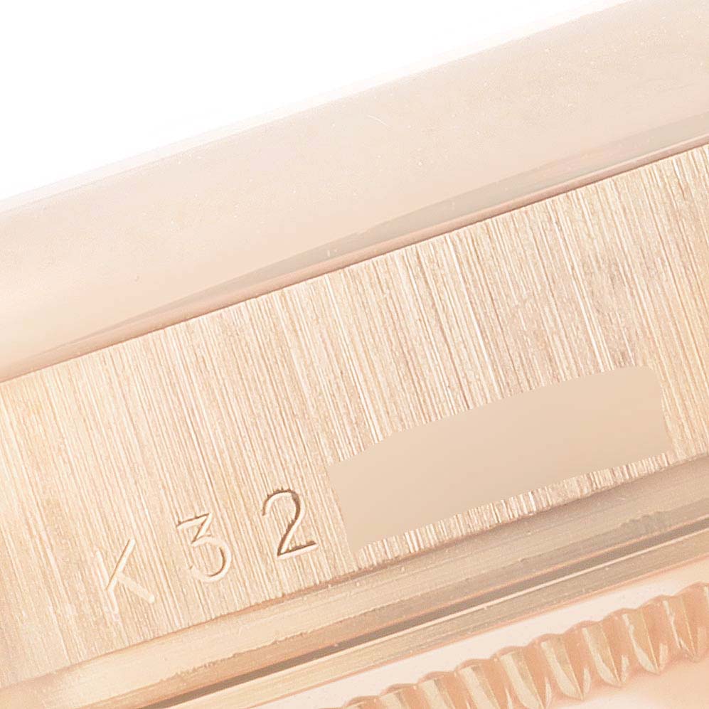 This close-up angle shows the side view of the case and serial number of a Rolex President 118205 Men's Rose Gold Silver Dial 118205 Men's Rose Gold Silver Dial model watch.