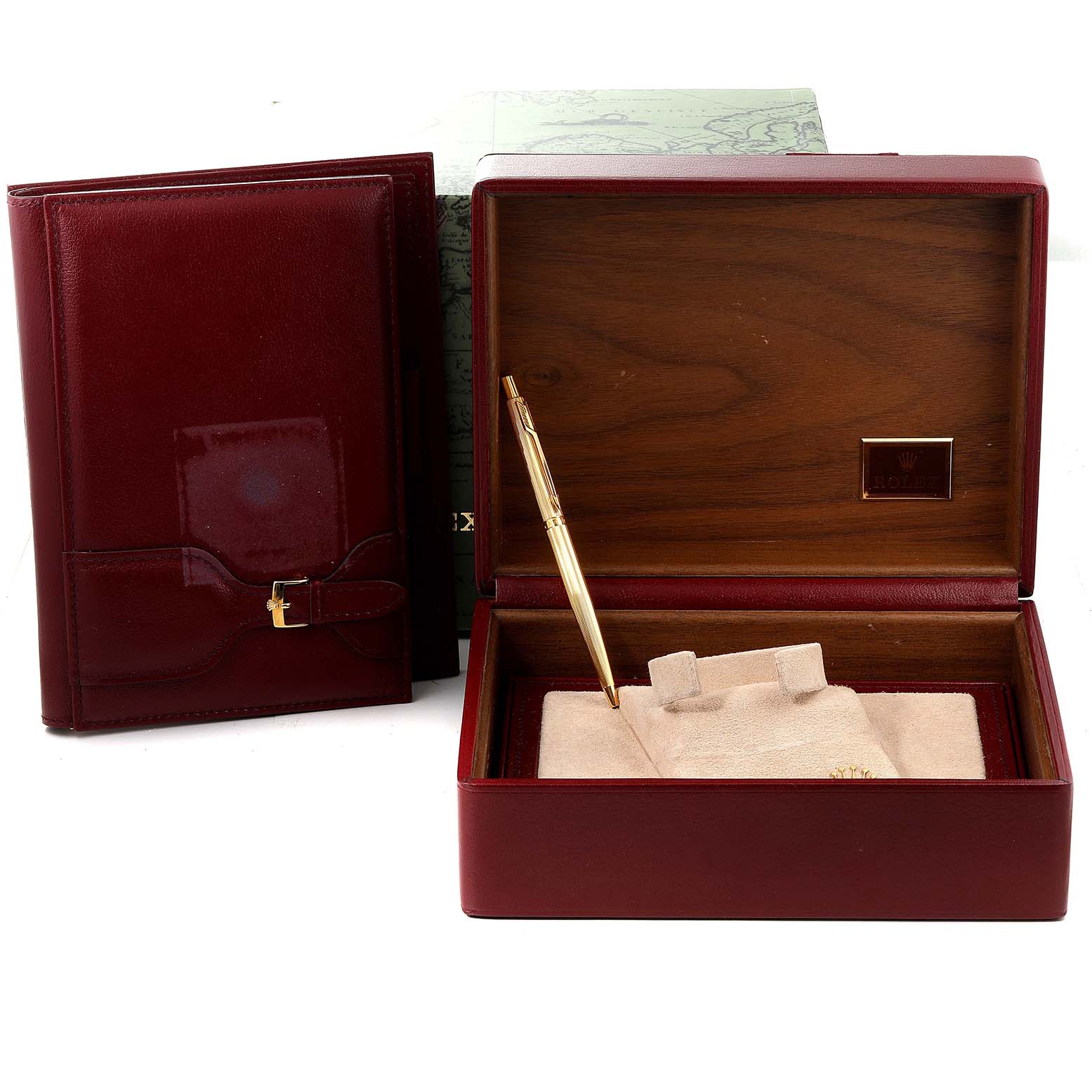 The image shows accessories for a Rolex President 18346 Men's Platinum Blue Dial 18346 Men's Platinum Blue Dial model, including a wooden watch box, a burgundy leather case, and a pen.