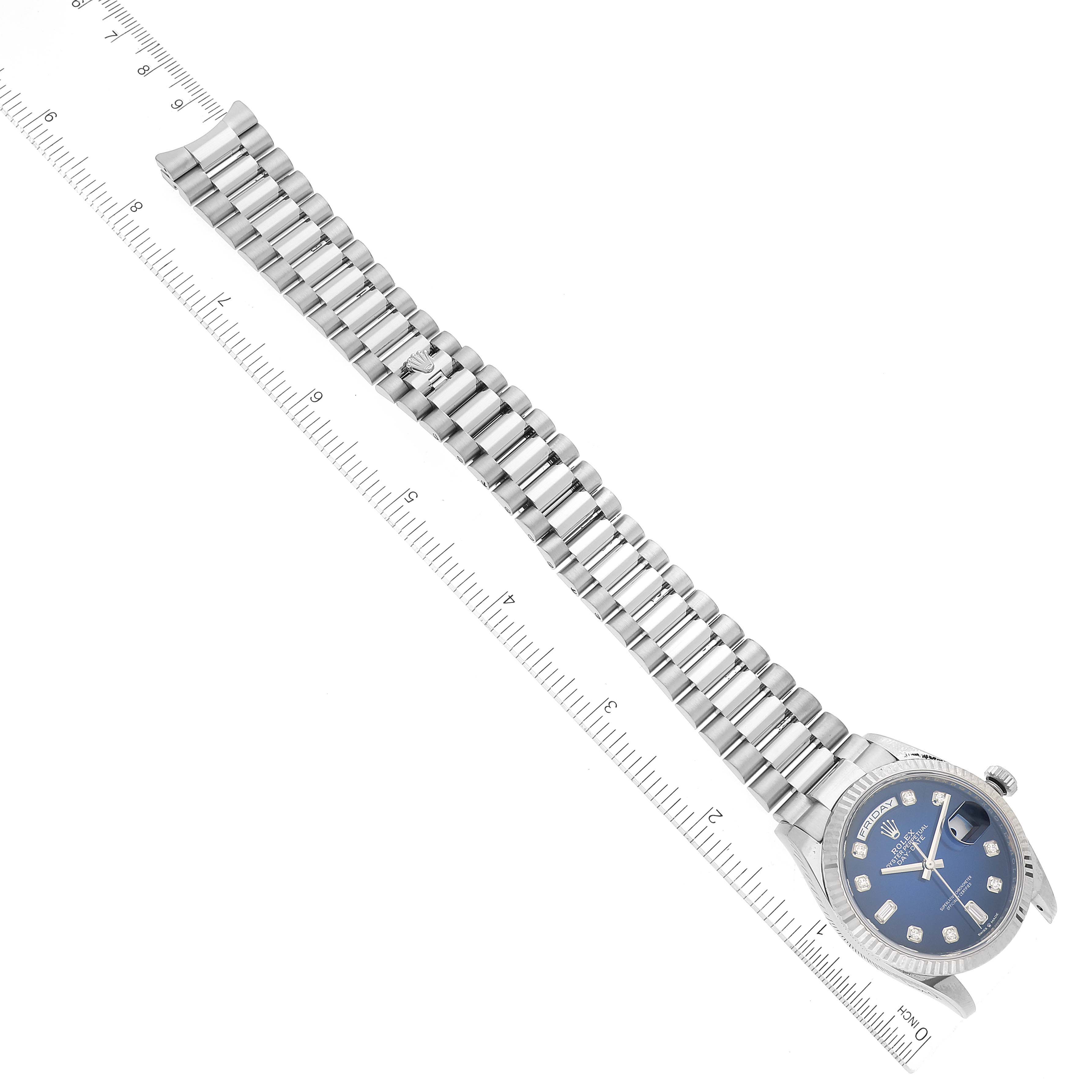 The image shows a Rolex President 128239 Men's White Gold Blue Dial 128239 Men's White Gold Blue Dial model watch laid flat with an extended bracelet and a visible dial, alongside a ruler for scale.