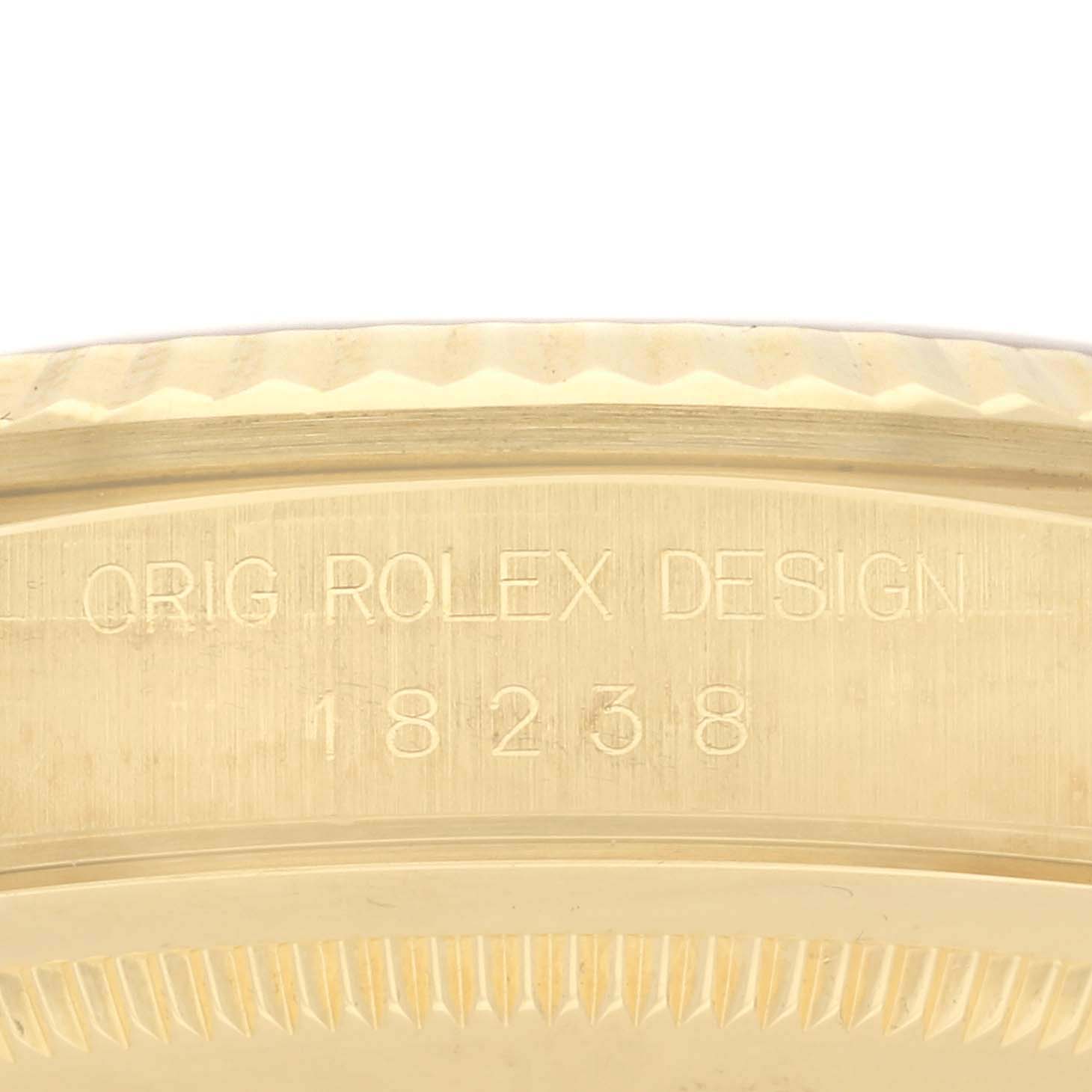 The image shows a close-up of the Rolex President 18238 Men
s Yellow Gold Champagne Dial 18238 Men
s Yellow Gold Champagne Dial model
s case edge with engraving, including the design reference number.