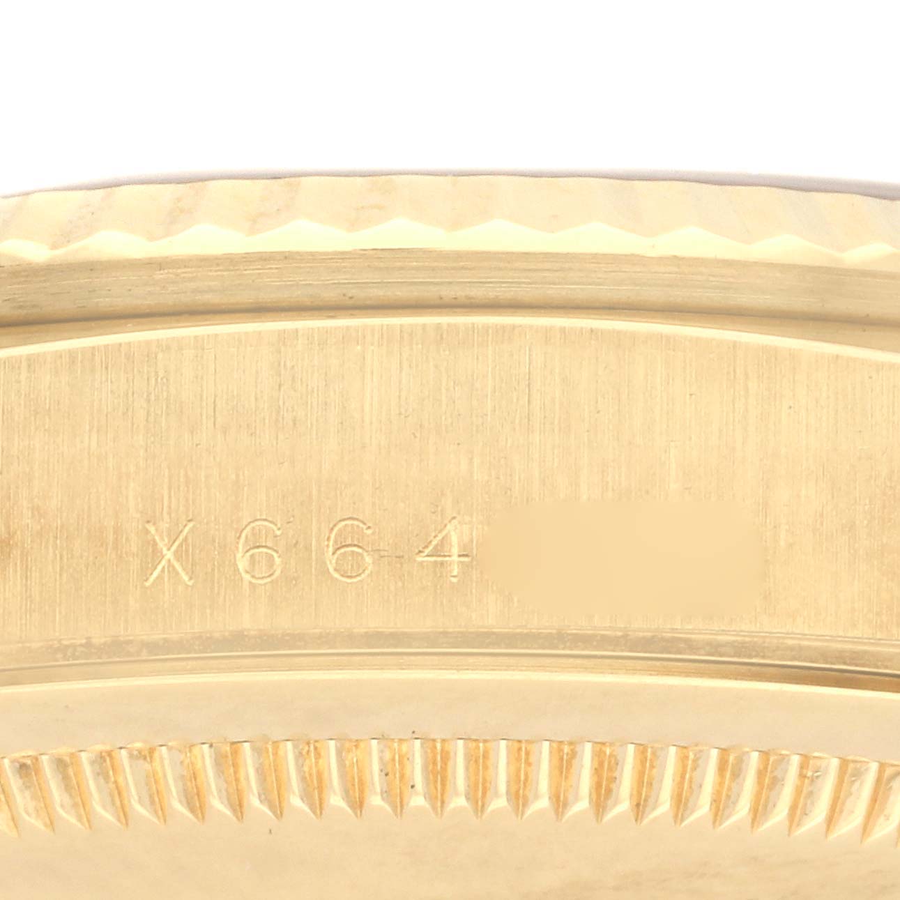 The image shows a close-up of the case side and bezel edge of a Rolex President 18238 Men
s Yellow Gold Champagne Dial 18238 Men
s Yellow Gold Champagne Dial watch with visible engraving.