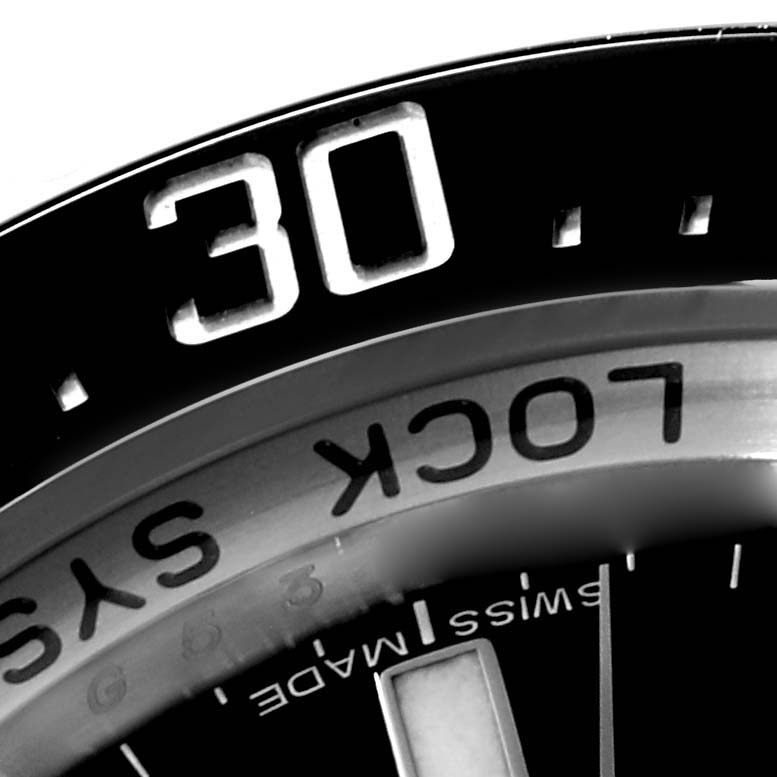 The image shows a close-up of the bezel and part of the dial of a Rolex Sea-Dweller 116660 Men's Stainless Steel Black Dial 116660 Men's Stainless Steel Black Dial watch.