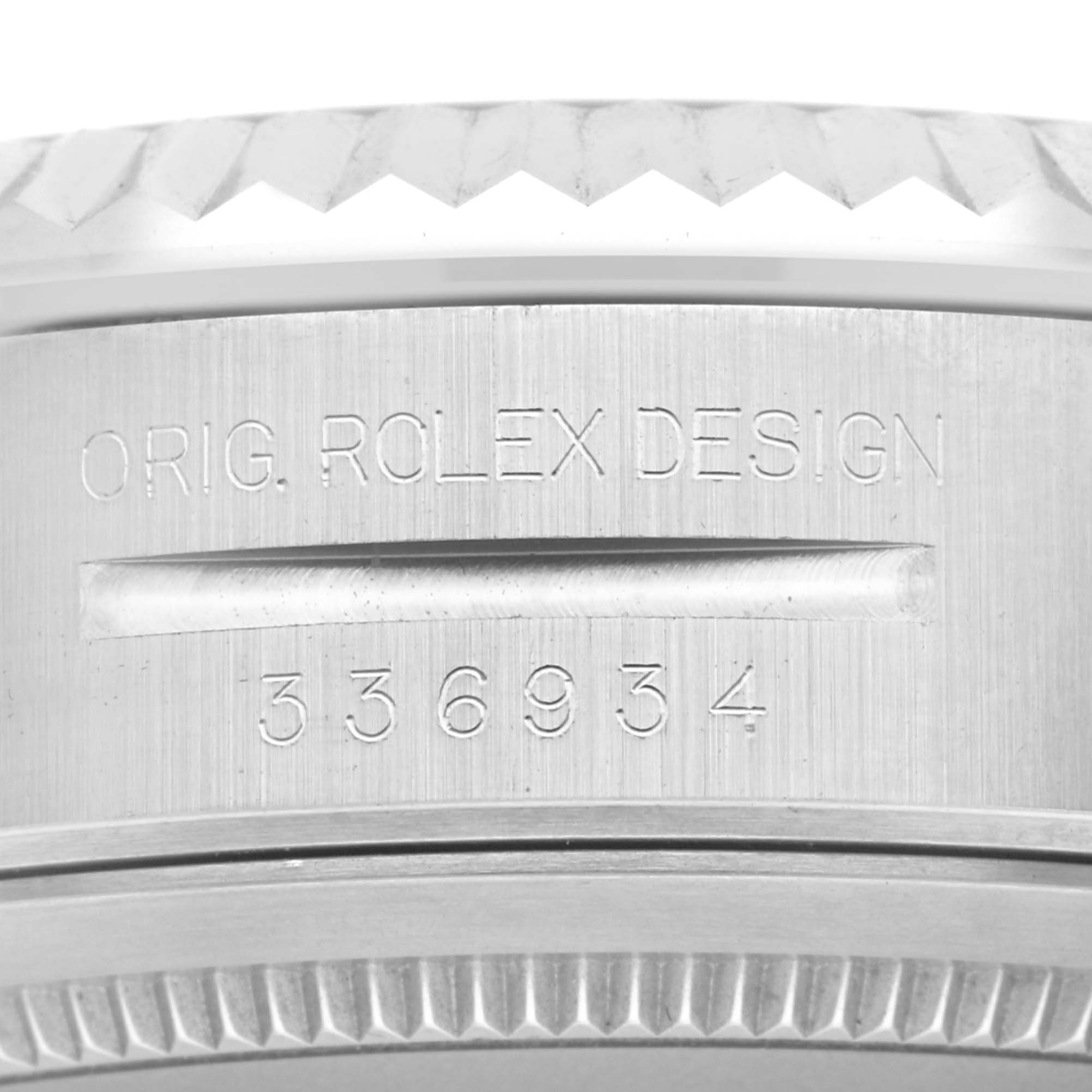 The image shows a close-up angle of the engraved side of the bezel of a Rolex Sky-Dweller 336934 Men
s Stainless Steel White Dial 336934 Men
s Stainless Steel White Dial watch.
