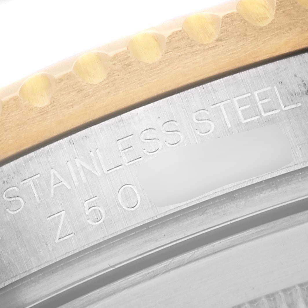 This close-up image shows the stainless steel casing and engraved serial number of the Rolex Submariner 16613 Men
s Steel and Gold (two tone) Blue Dial 16613 Men
s Steel and Gold (two tone) Blue Dial watch.