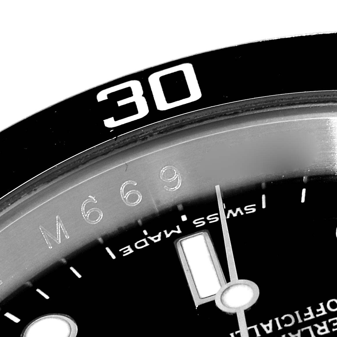 This close-up image of the Rolex Submariner 16610 Men
s Stainless Steel Black Dial 16610 Men
s Stainless Steel Black Dial watch displays the bezel, part of the dial, and the minute hand.
