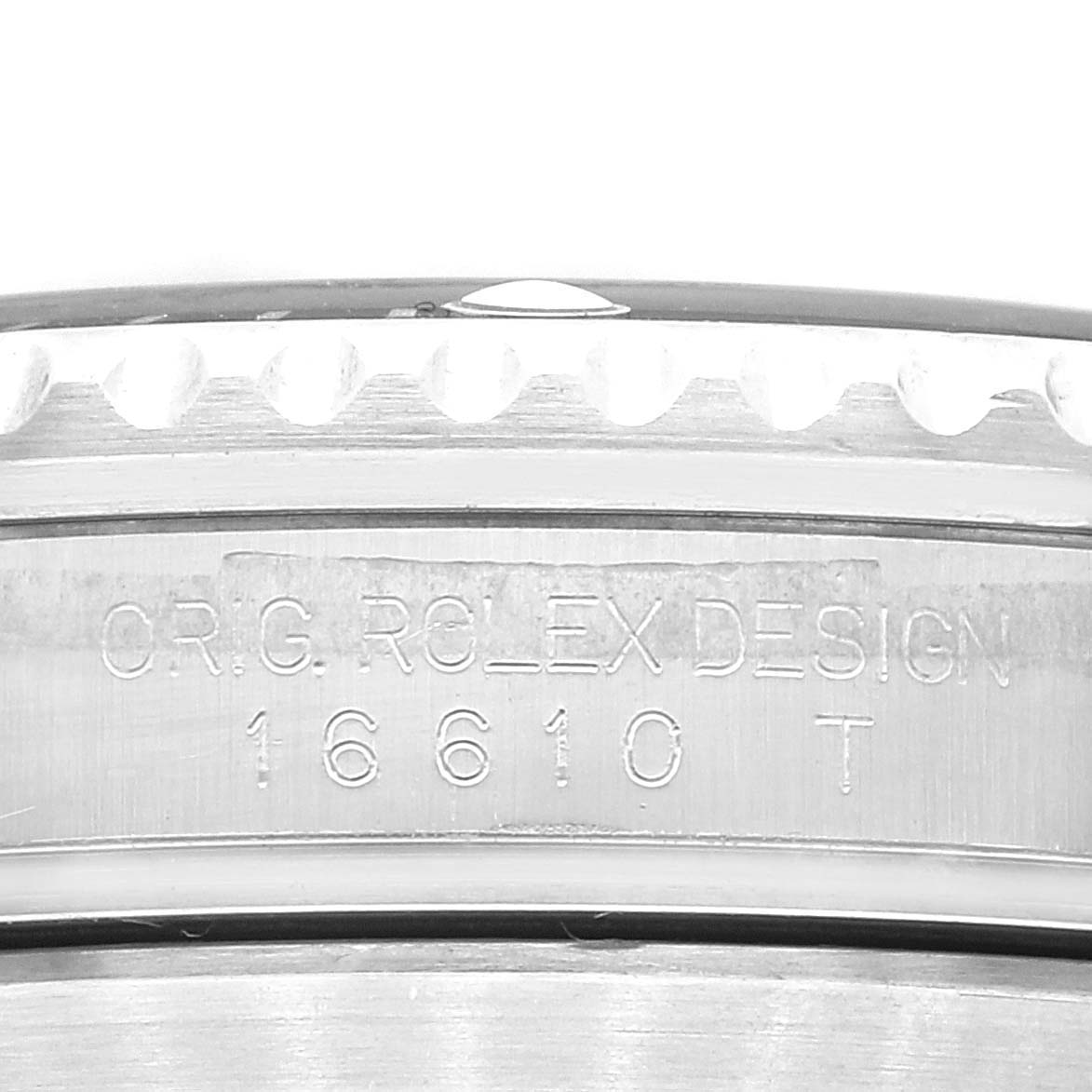 This close-up image shows the engraved case back of a Rolex Submariner 16610 Men
s Stainless Steel Black Dial 16610 Men
s Stainless Steel Black Dial, focusing on its model number 16610.