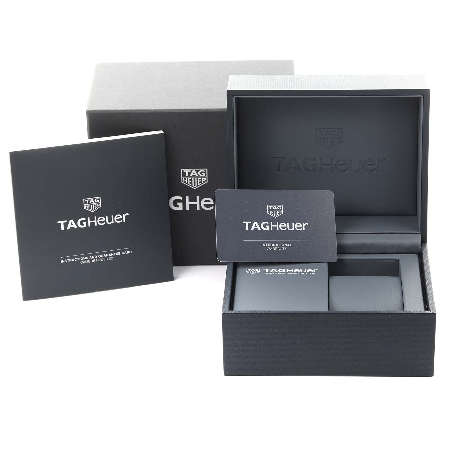 The image shows a Tag Heuer Carrera CAR2050.FC6426 Men's Steel and Gold (two tone) Black Dial CAR2050.FC6426 Men's Steel and Gold (two tone) Black Dial box, user manuals, and an international warranty card at an angled view.