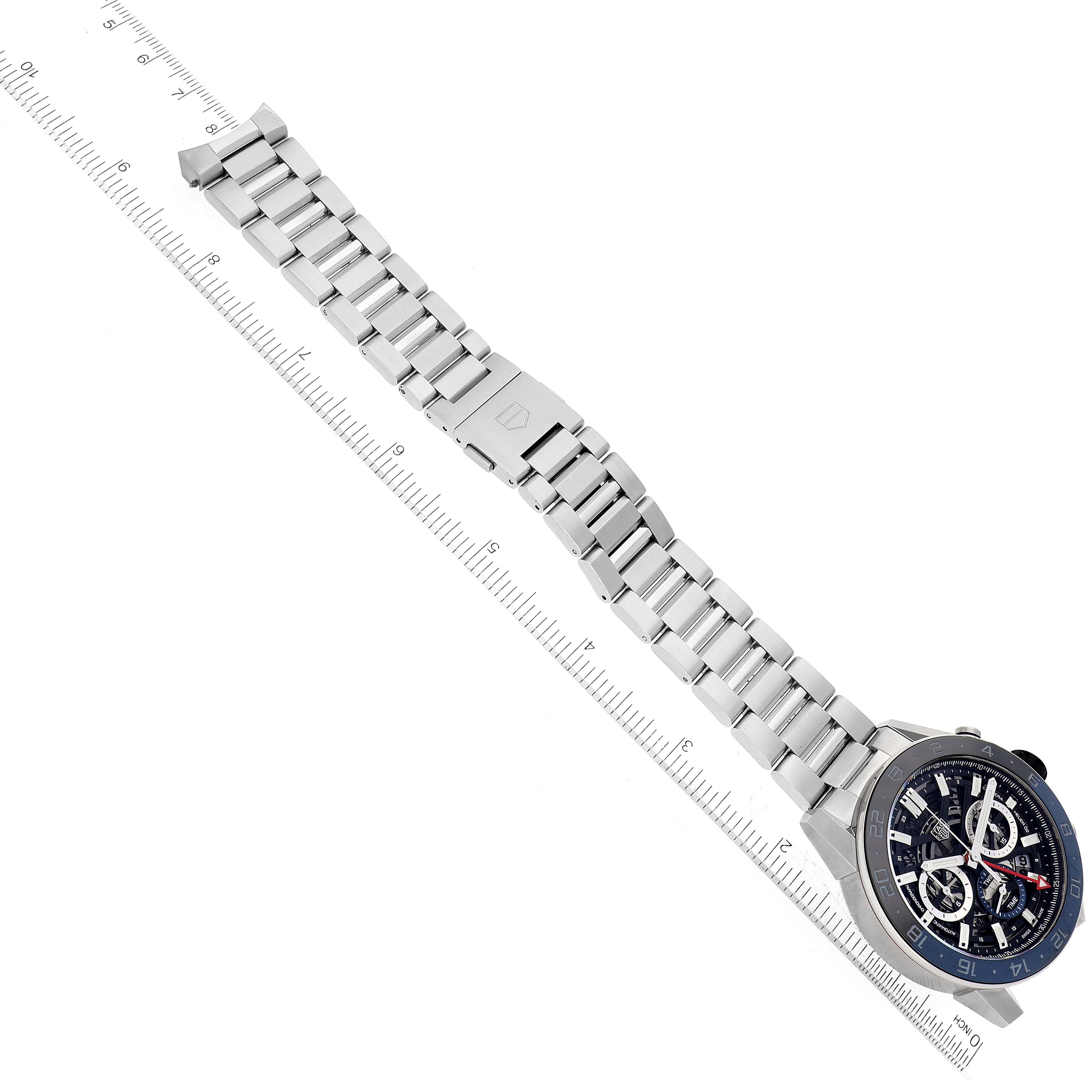 The image shows a Tag Heuer Carrera CBG2A1Z.BA0658 Men's Stainless Steel Transparent Dial CBG2A1Z.BA0658 Men's Stainless Steel Transparent Dial watch with a stainless steel bracelet laid next to a ruler.