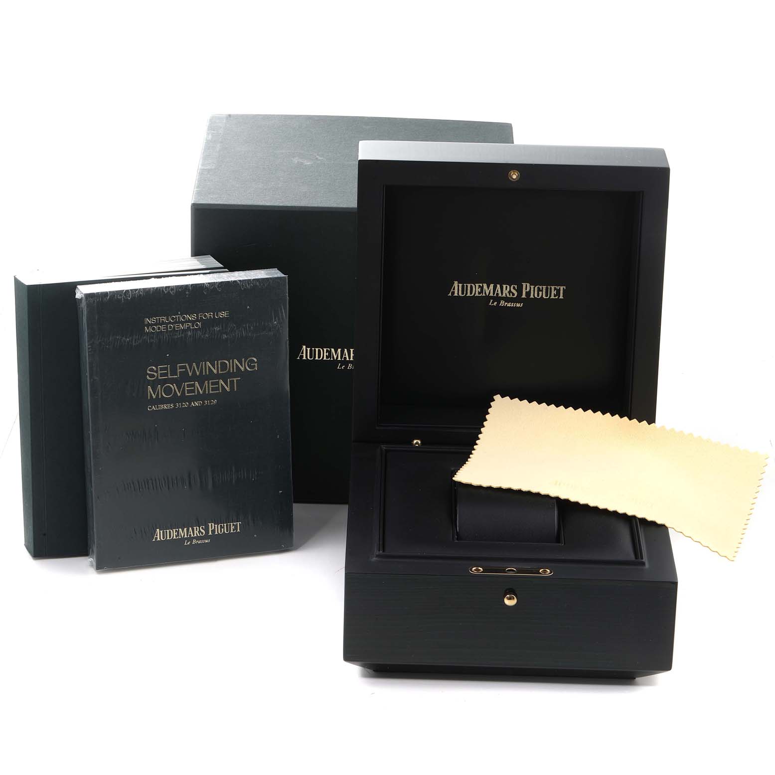 The image shows the packaging, box, manuals, and a cleaning cloth for an Audemars Piguet Royal Oak 15451ST.ZZ.1256ST.01 Men's Stainless Steel Black Dial 15451ST.ZZ.1256ST.01 Men's Stainless Steel Black Dial model watch.