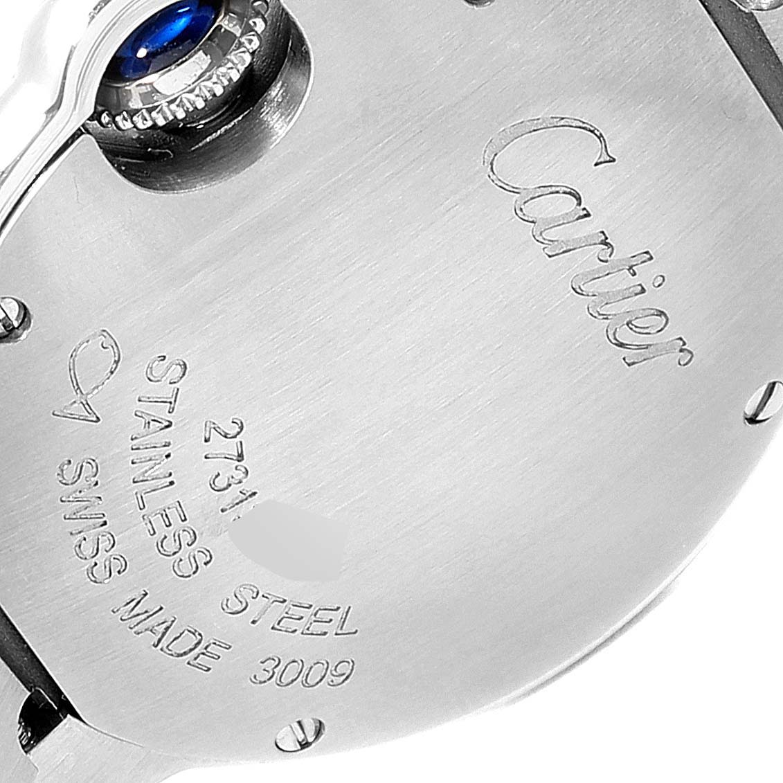 The image shows the back casing and crown of the Ballon Bleu model by Cartier, highlighting its stainless steel construction and engraving.