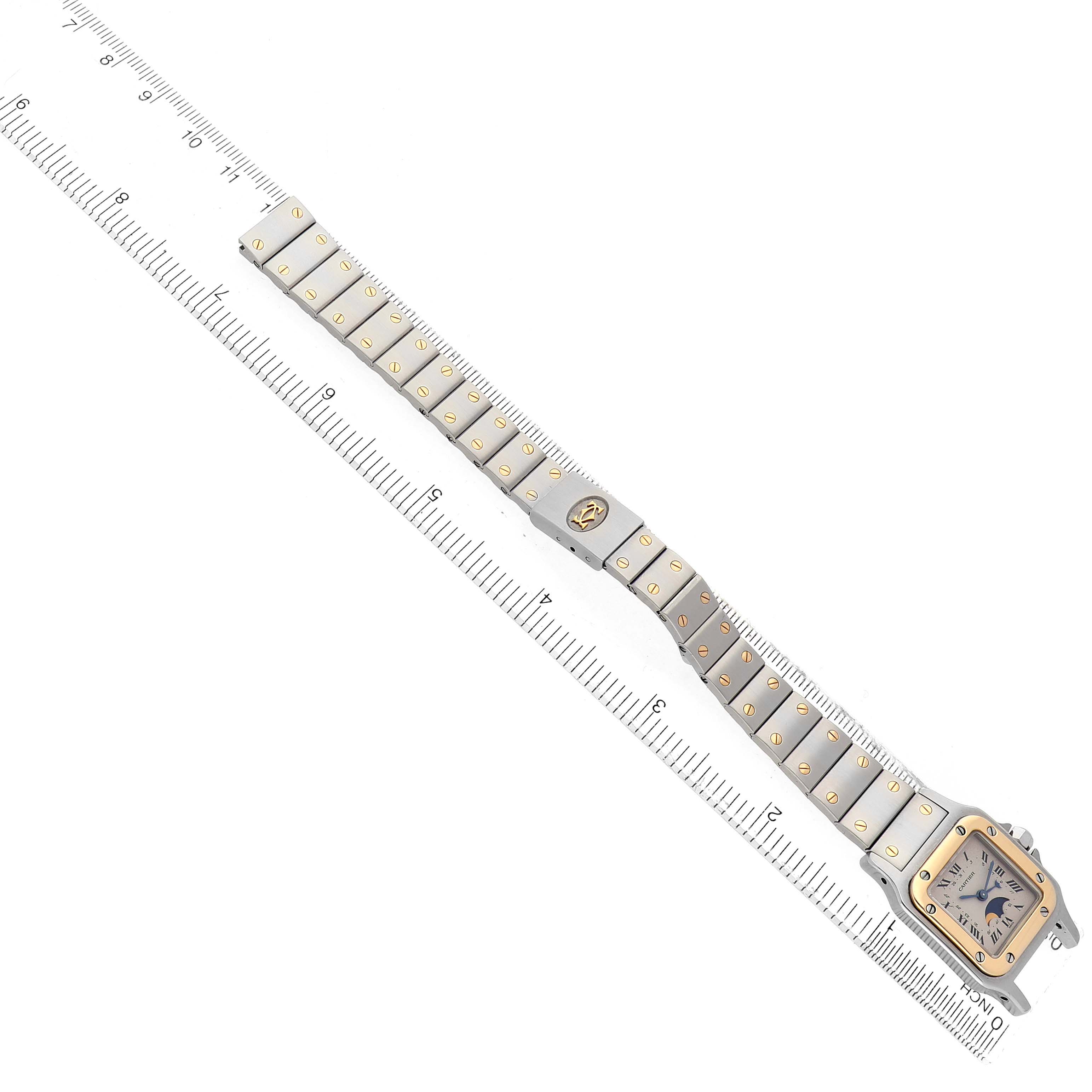 The Cartier Santos W20008C4 Women's Steel and Gold (two tone) Silver Dial watch is shown from a top-down angle, displaying its full bracelet and square case.