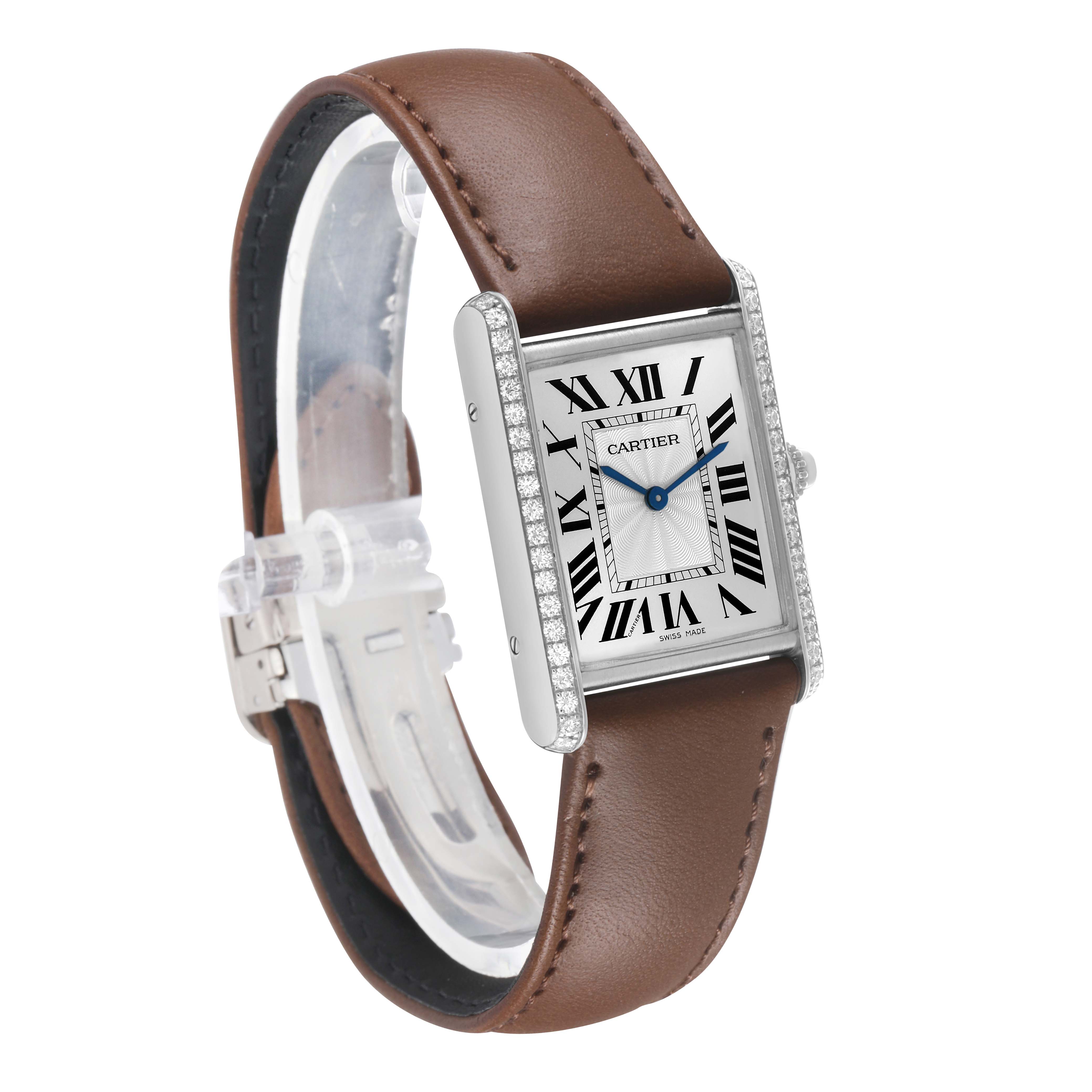 The Cartier Tank Louis WJTA0015 Women's White Gold Silver Dial watch is shown at an angled side view, displaying its face, case, and brown leather strap.