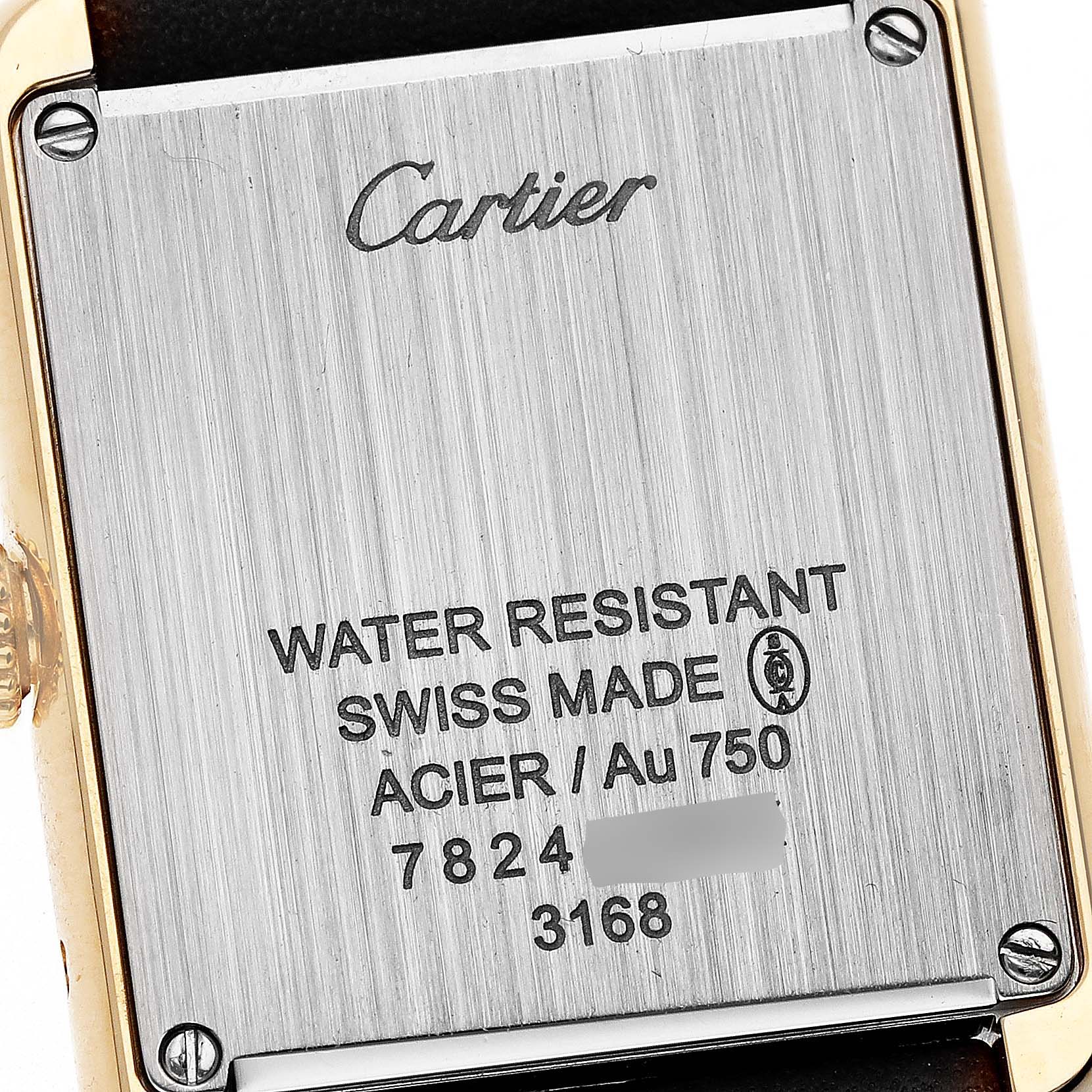 The image shows the back of the Cartier Tank Solo W5200002 Women's Yellow Gold Silver Dial watch with inscriptions and screw details.