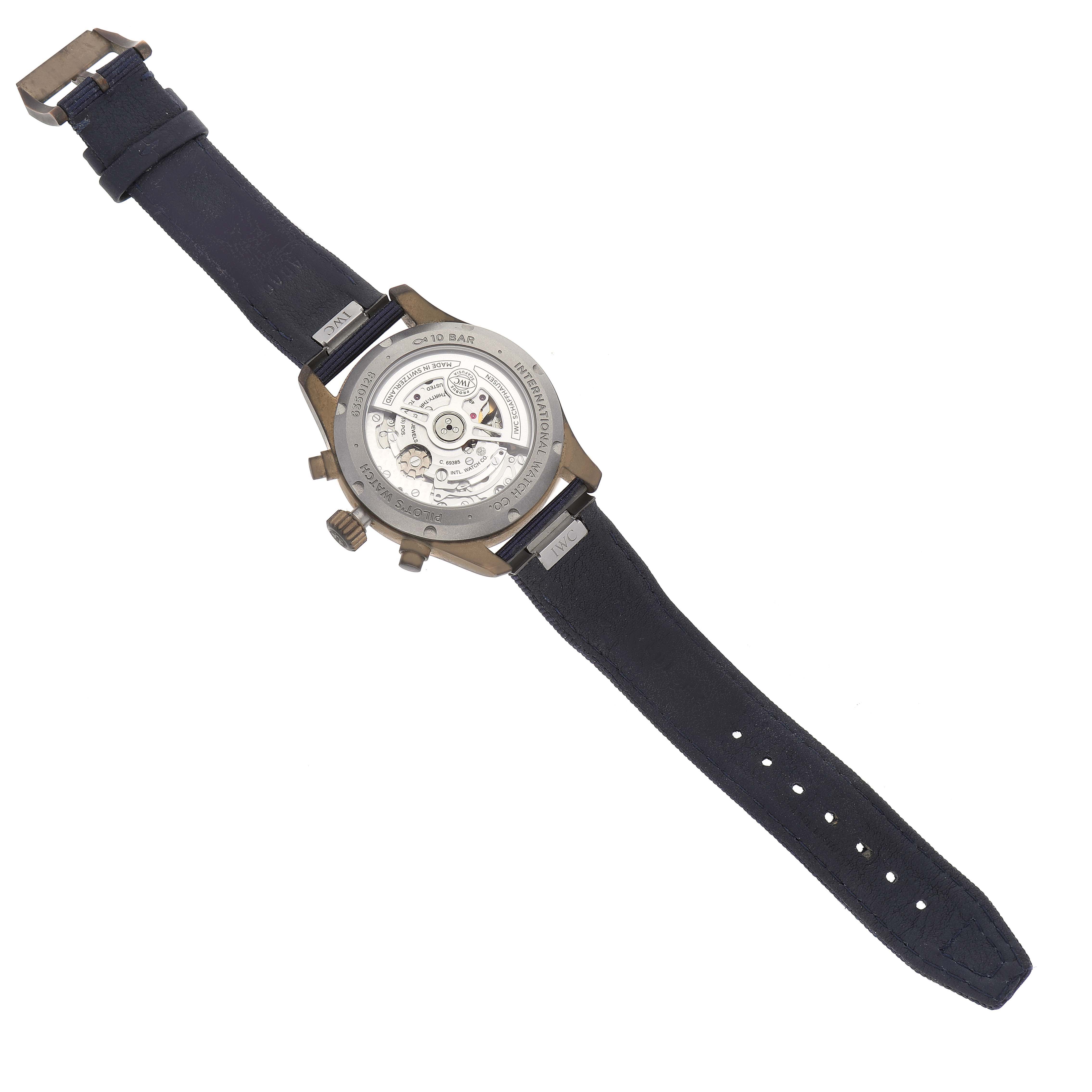 The IWC Pilot IW388109 Men's Bronze Blue Dial IW388109 Men's Bronze Blue Dial model watch is shown from the back, displaying its open case back and black strap.