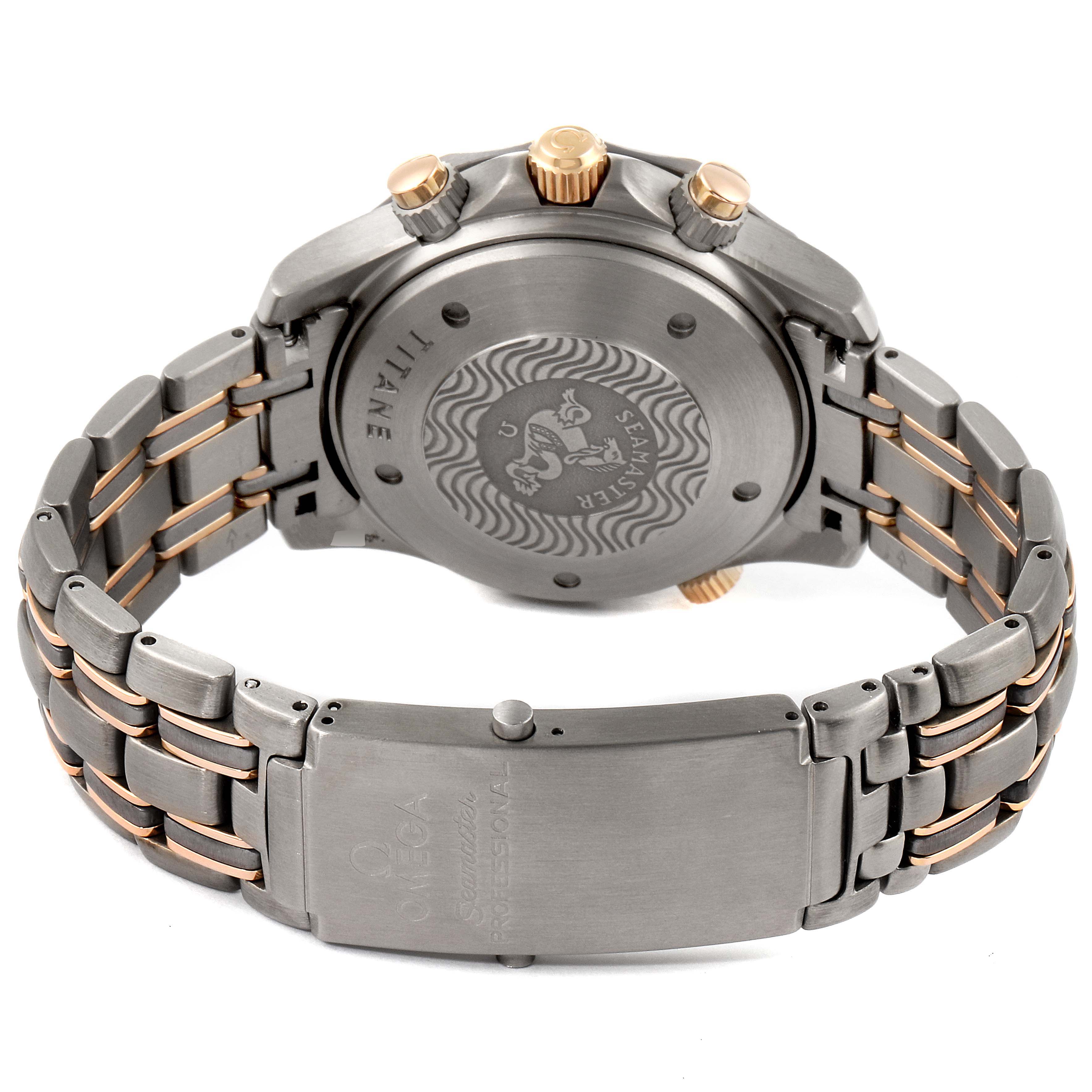 The image shows the back case and bracelet of an Omega Seamaster 2296.80.00 Men's Steel and Gold (two tone) Blue Dial 2296.80.00 Men's Steel and Gold (two tone) Blue Dial model watch, highlighting the engraving and clasp.