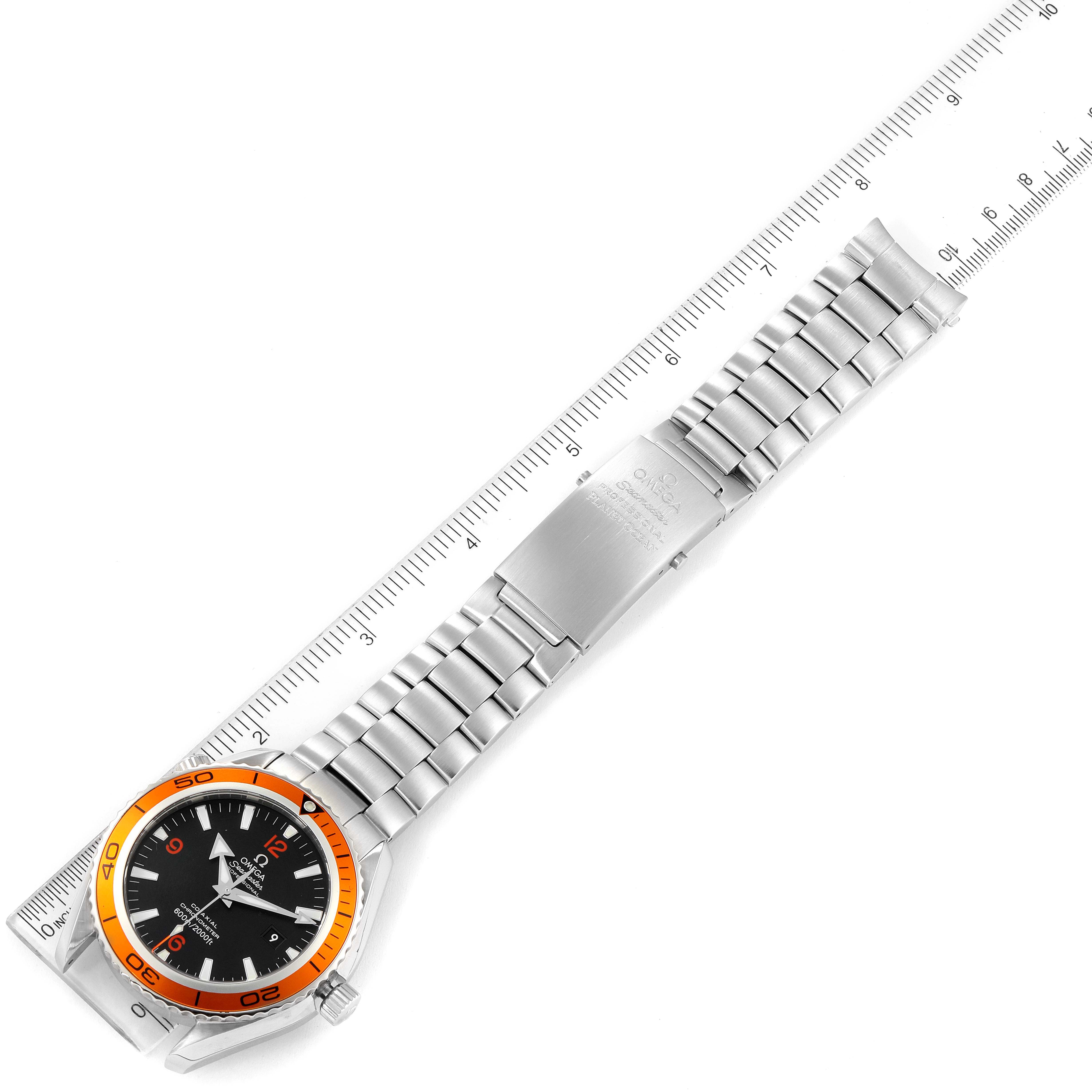 The Omega Planet Ocean 2208.50.00 Men
s Stainless Steel Black Dial 2208.50.00 Men
s Stainless Steel Black Dial watch is shown from an overhead angle, displaying its face, bezel, bracelet, and clasp alongside a ruler for scale.