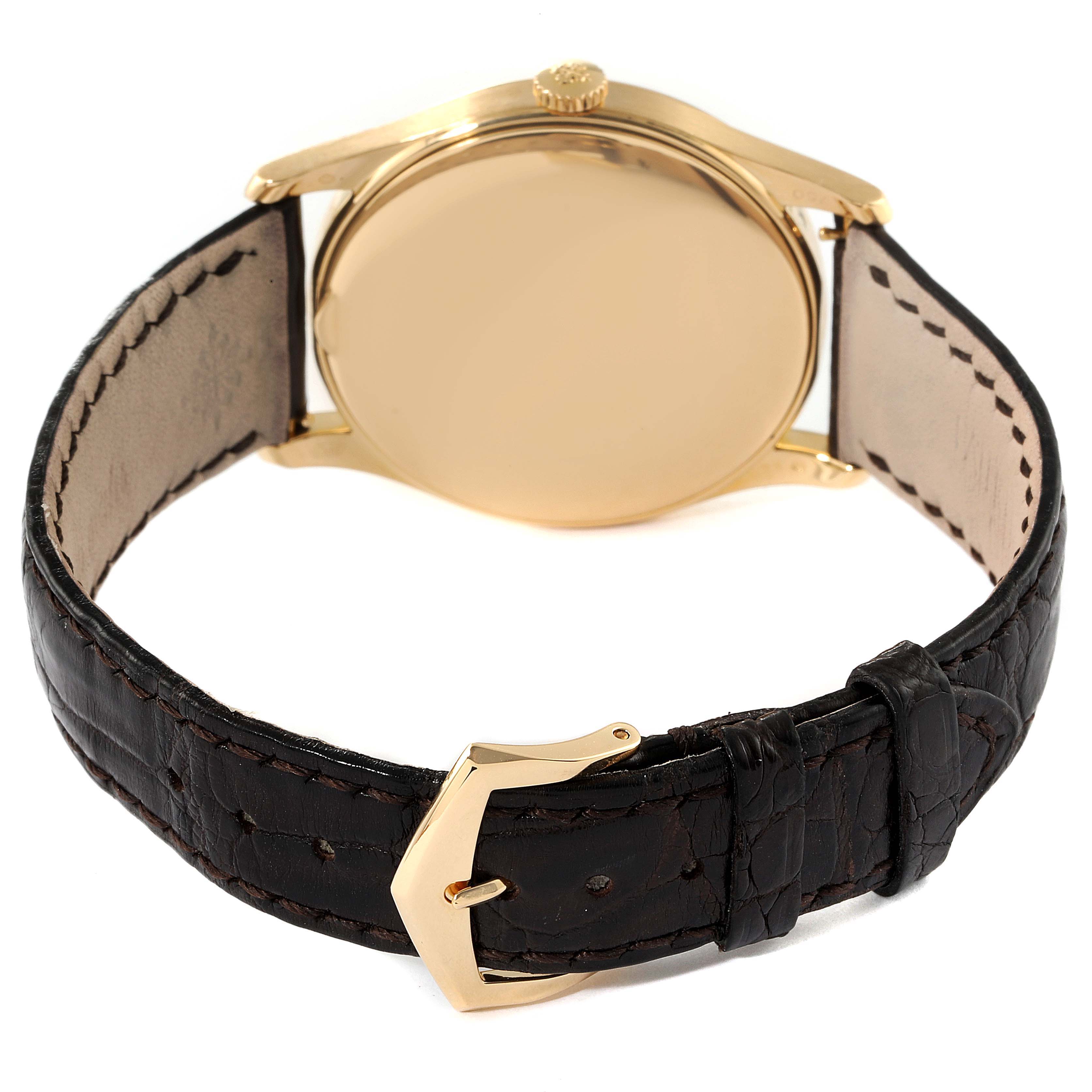 The image shows the back and strap of a Patek Philippe Calatrava 5196J Men's Yellow Gold Silver Dial 5196J Men's Yellow Gold Silver Dial watch, highlighting the gold case and black leather band.