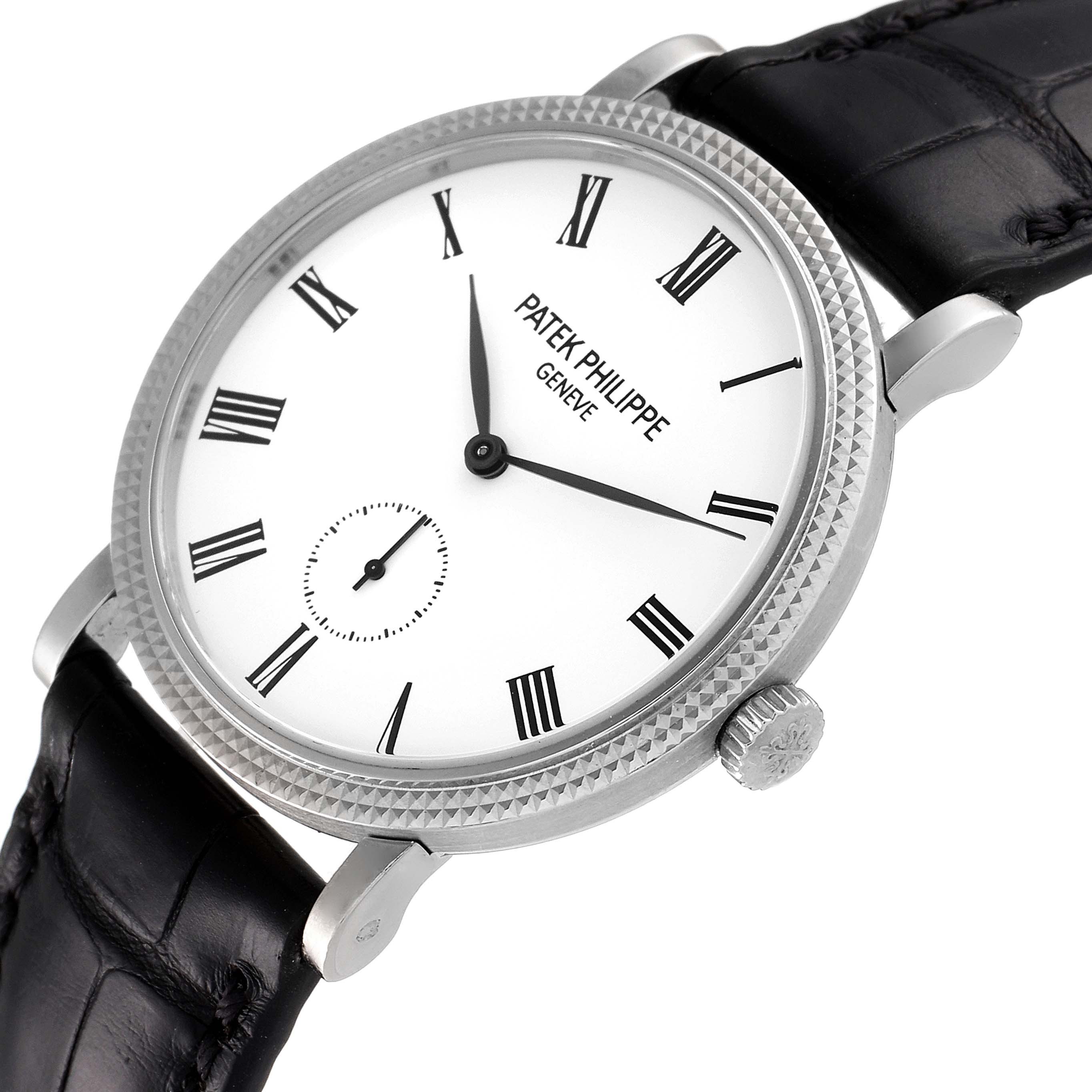 The Patek Philippe Calatrava 7119G Women's White Gold White Dial 7119G Women's White Gold White Dial watch is shown at an angled view featuring its dial, bezel, crown, and a part of the black leather strap.