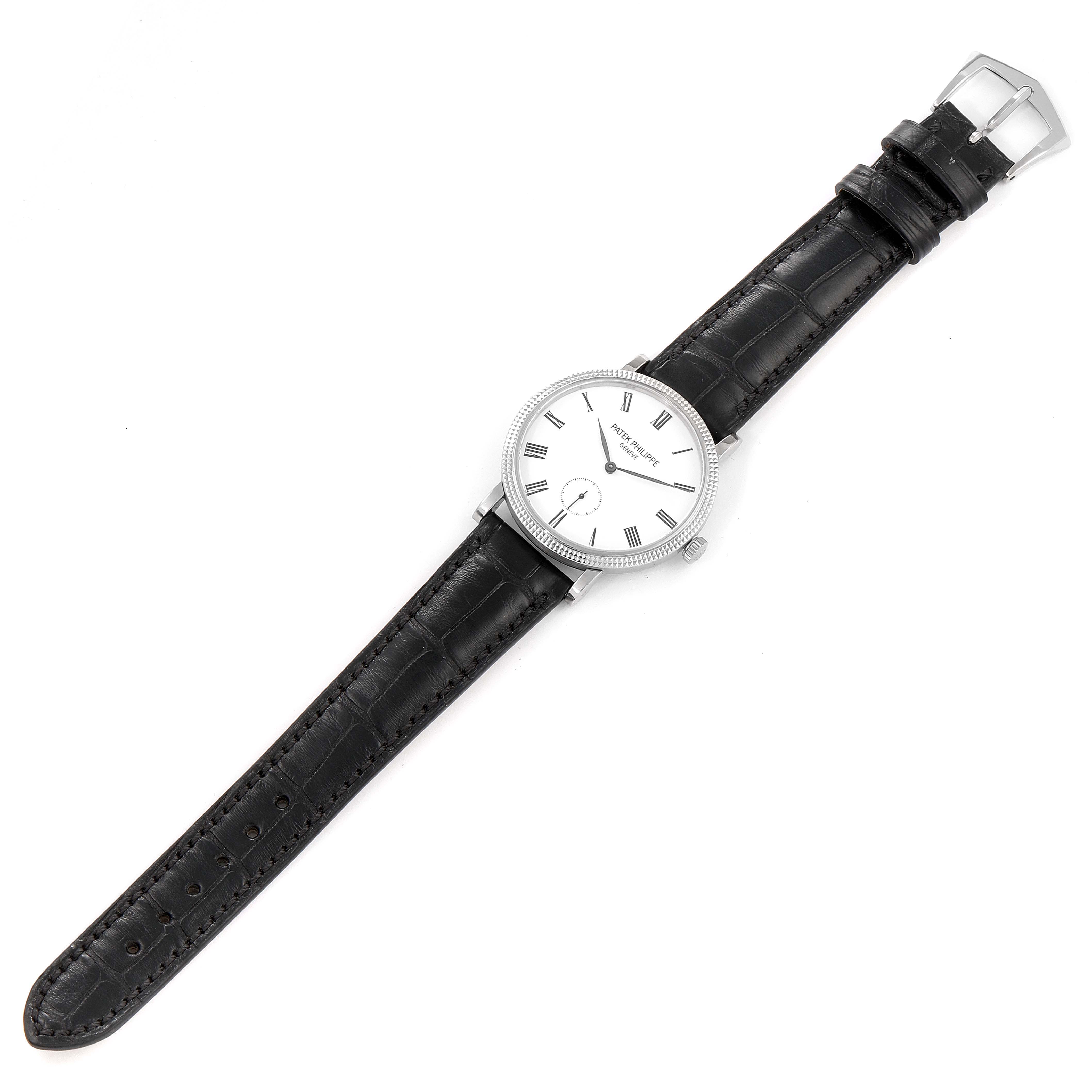 This image shows a top view of the Patek Philippe Calatrava 7119G Women's White Gold White Dial 7119G Women's White Gold White Dial watch, featuring its entire face, case, and leather strap.