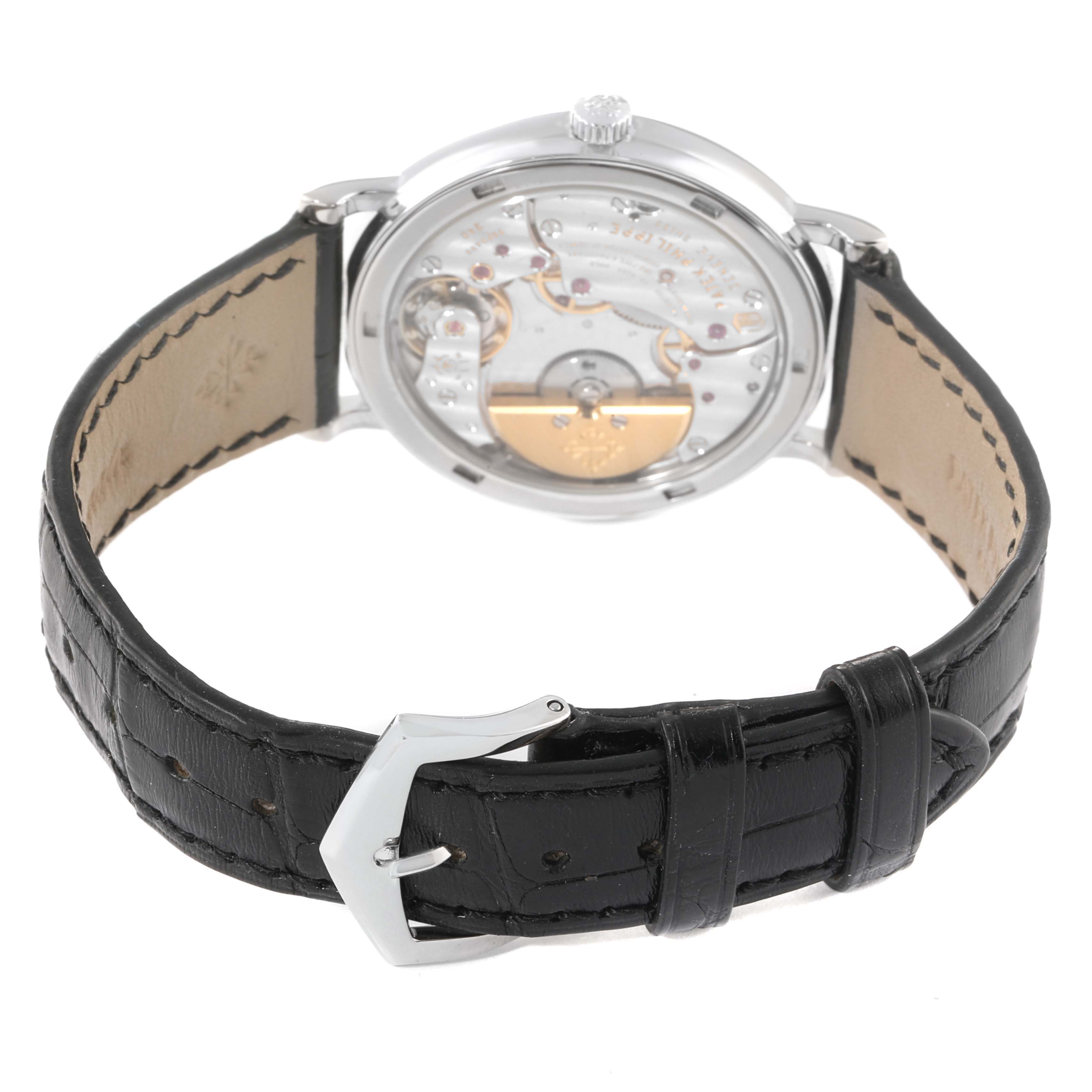 The image shows a rear angle of the Patek Philippe Calatrava 5120G Men's White Gold White Dial 5120G Men's White Gold White Dial watch, highlighting the movement and black leather strap with buckle.