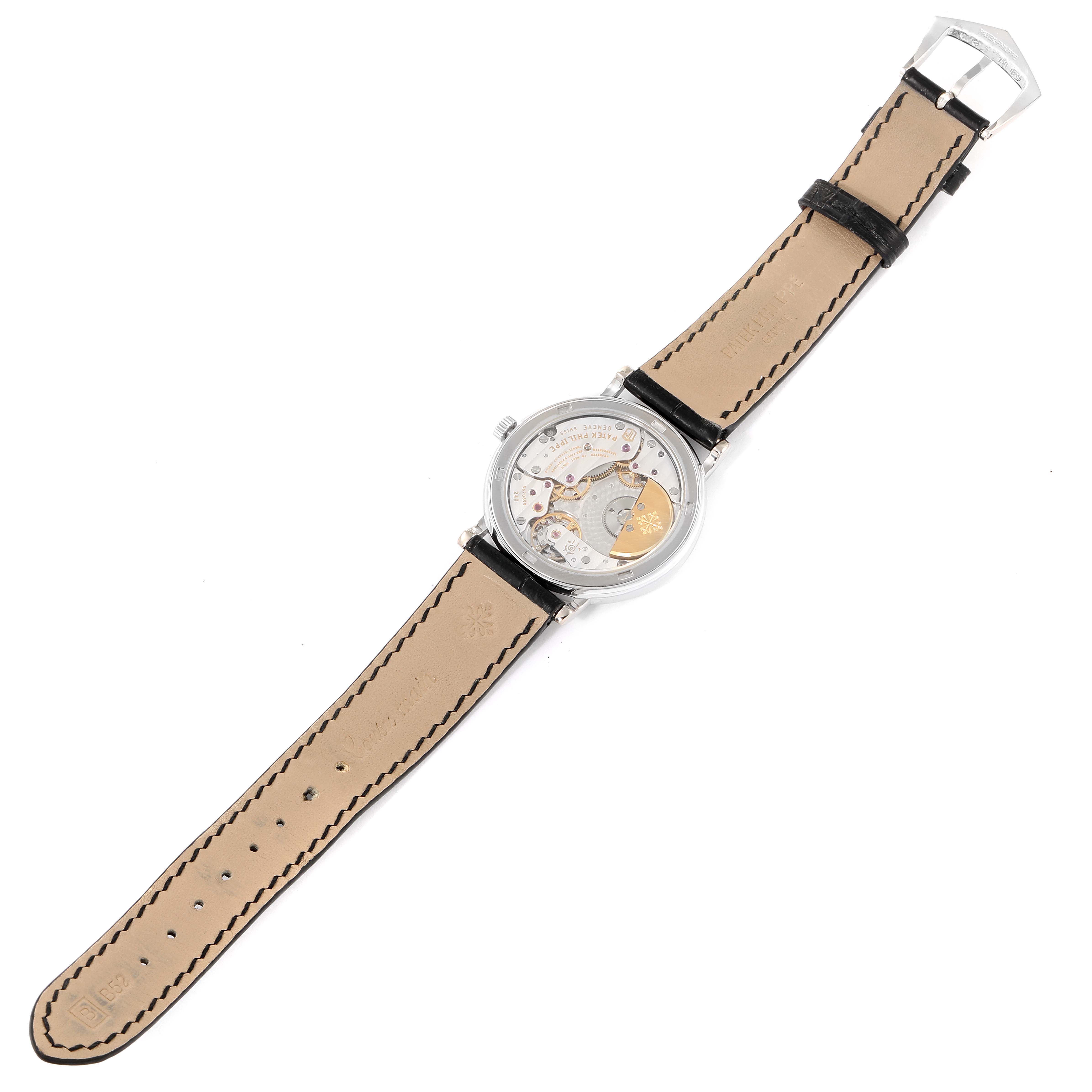 This image shows the back view of a Patek Philippe Calatrava 5120G Men's White Gold White Dial 5120G Men's White Gold White Dial watch, highlighting its leather strap and intricate movement.