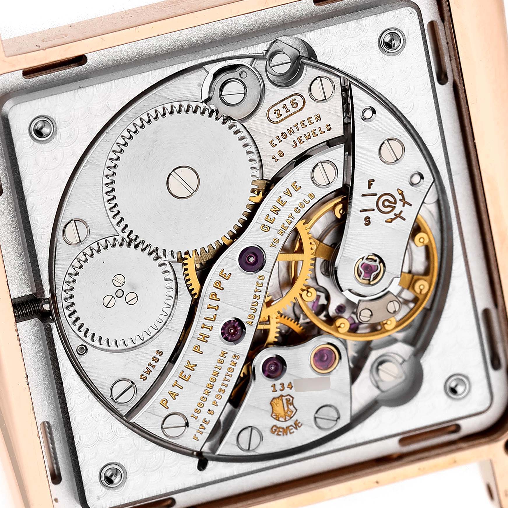 The image shows the intricate movement of a Patek Philippe Gondolo 5489R Men's Rose Gold Silver Dial watch from a top-down angle, detailing gears and inscriptions.