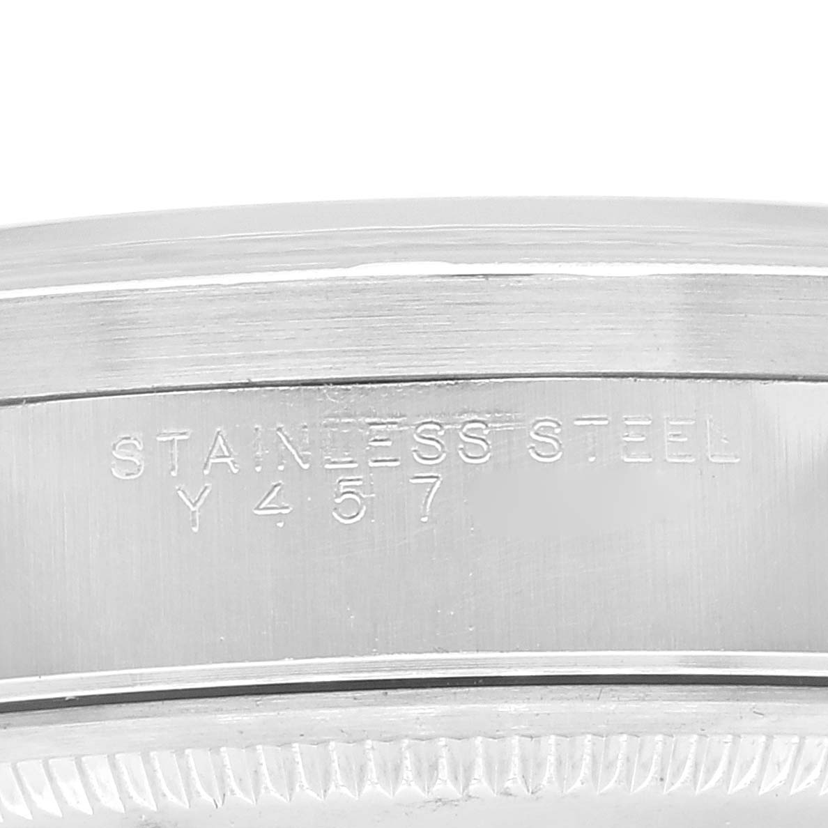 This image shows the side view of the stainless steel case back of a Rolex Air-King 14010 Men's Stainless Steel Silver Dial 14010 Men's Stainless Steel Silver Dial watch with engraved details.