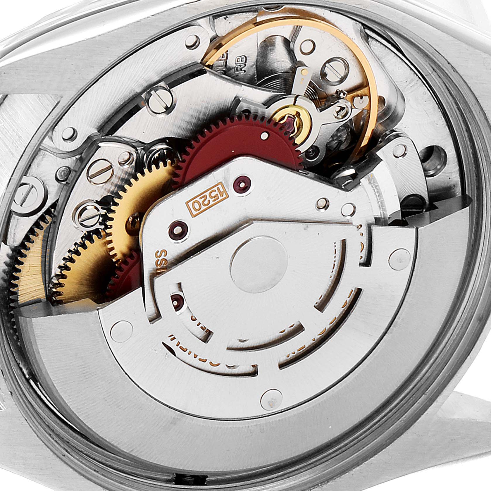 The image shows the internal mechanism of a Vintage Collection Rolex watch, highlighting gears and components from a close-up angle.